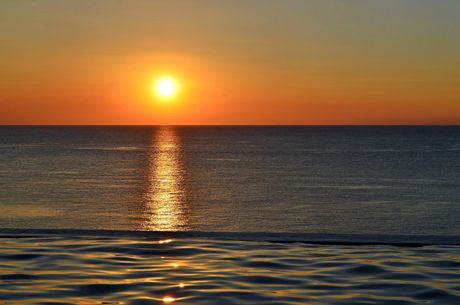 The sun is setting over the ocean
