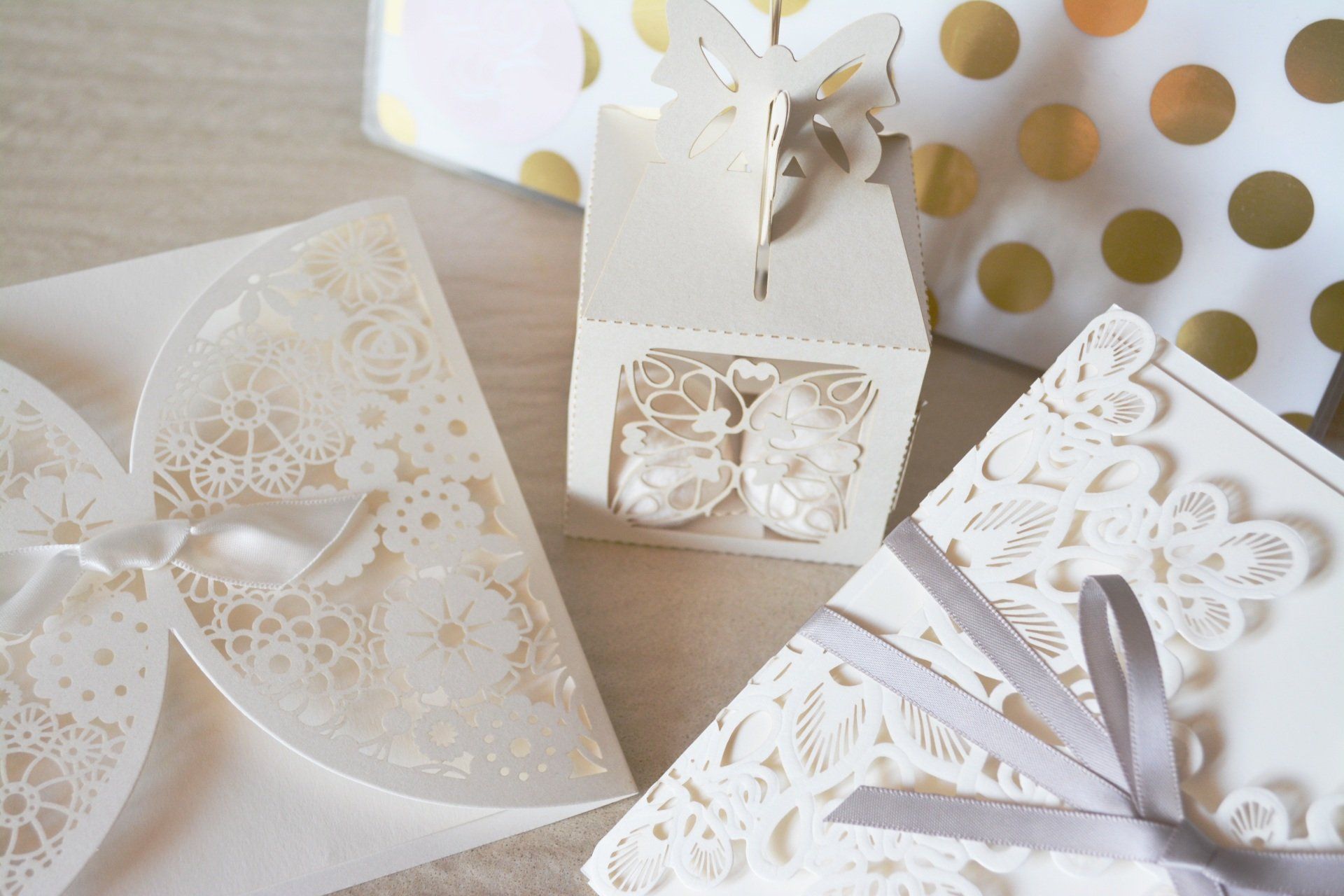 A table topped with a variety of wedding invitations and gifts.