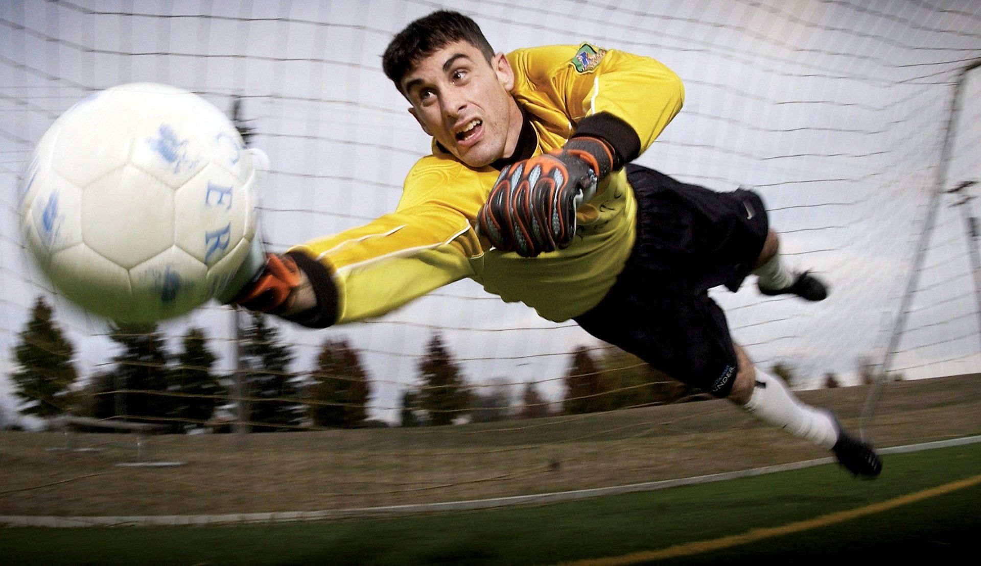 Soccer goalie stopping a soccer ball