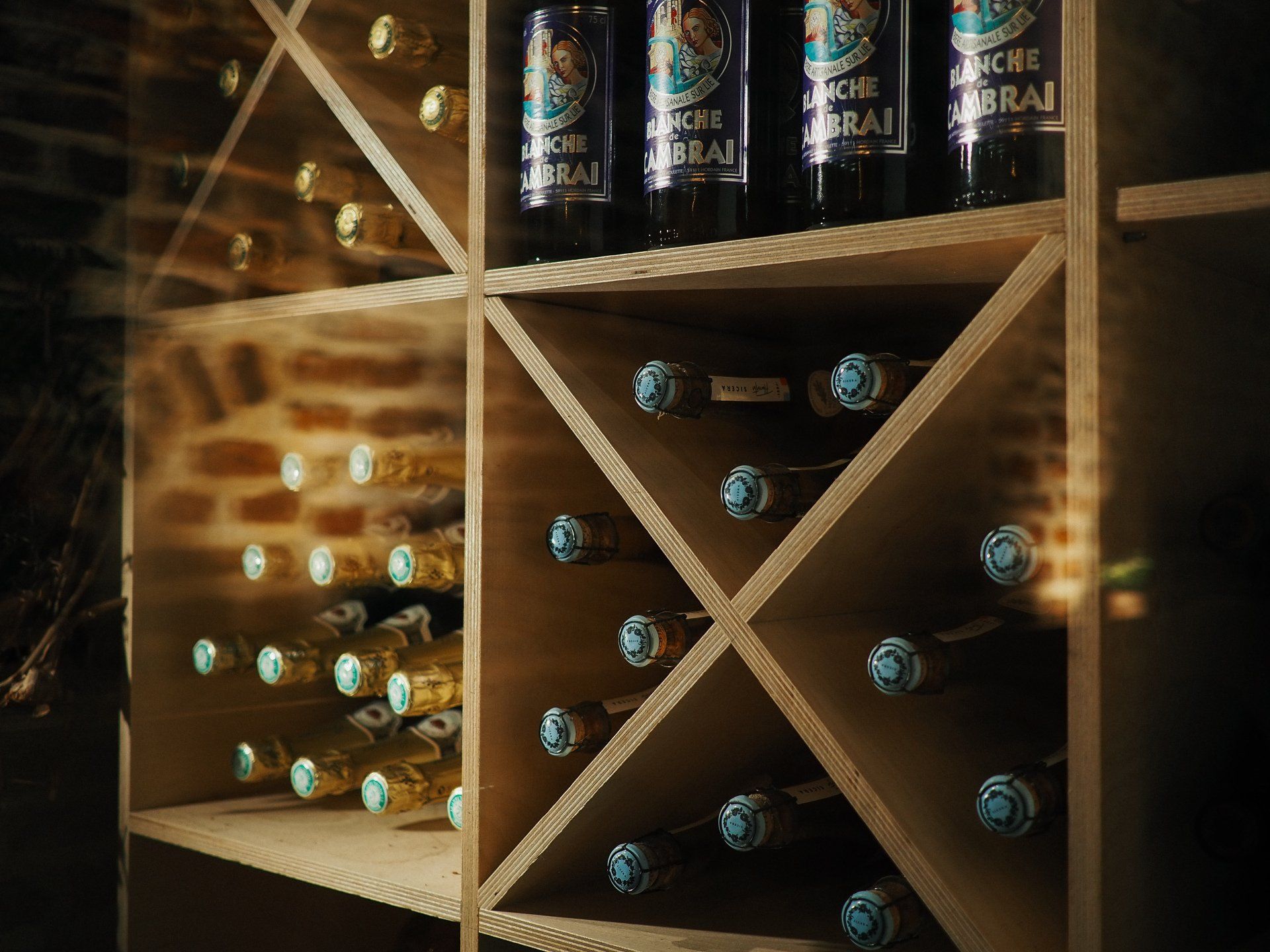 A wooden wine rack filled with bottles of wine