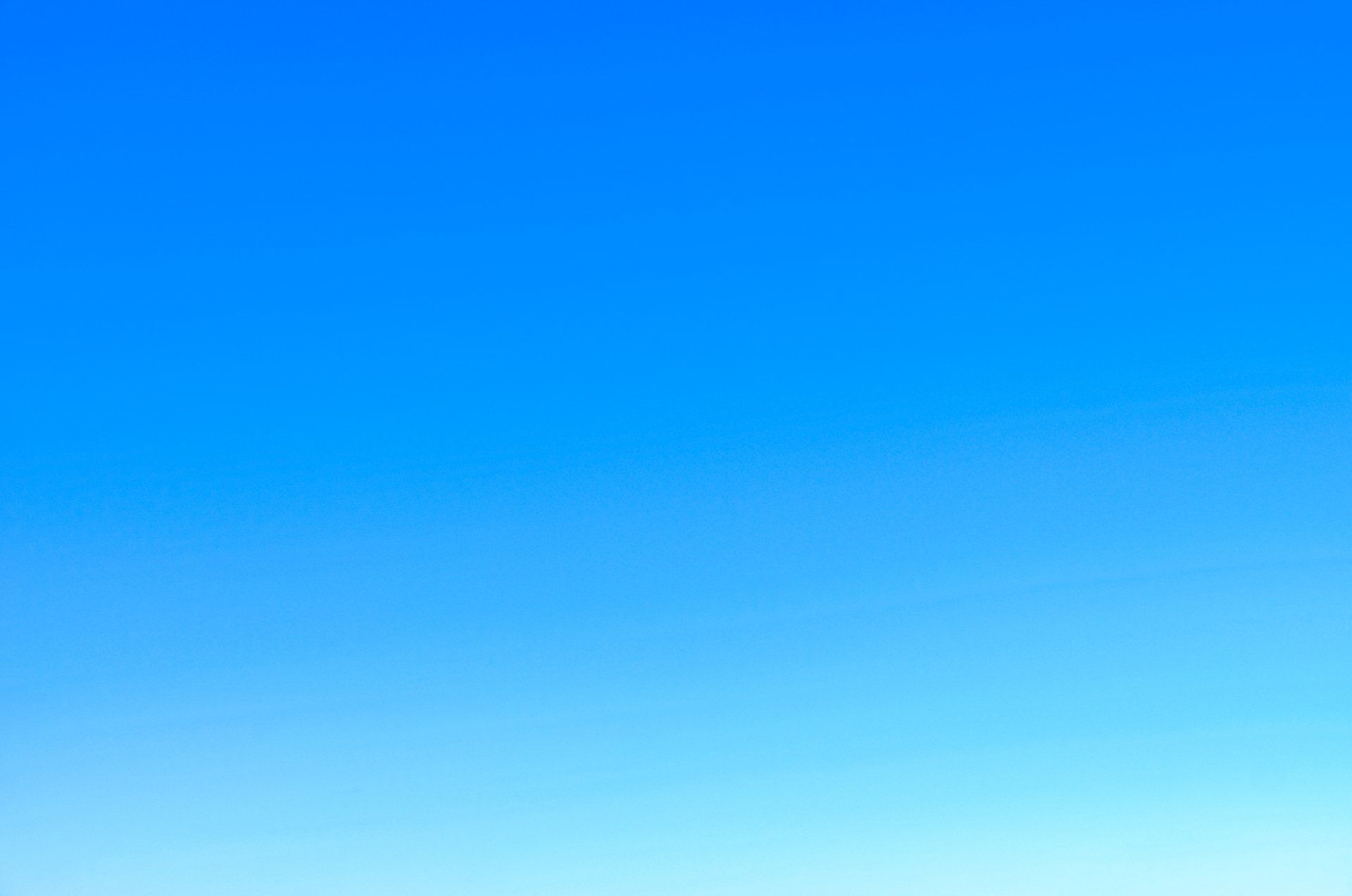 Vibrant gradient of clear blue sky.