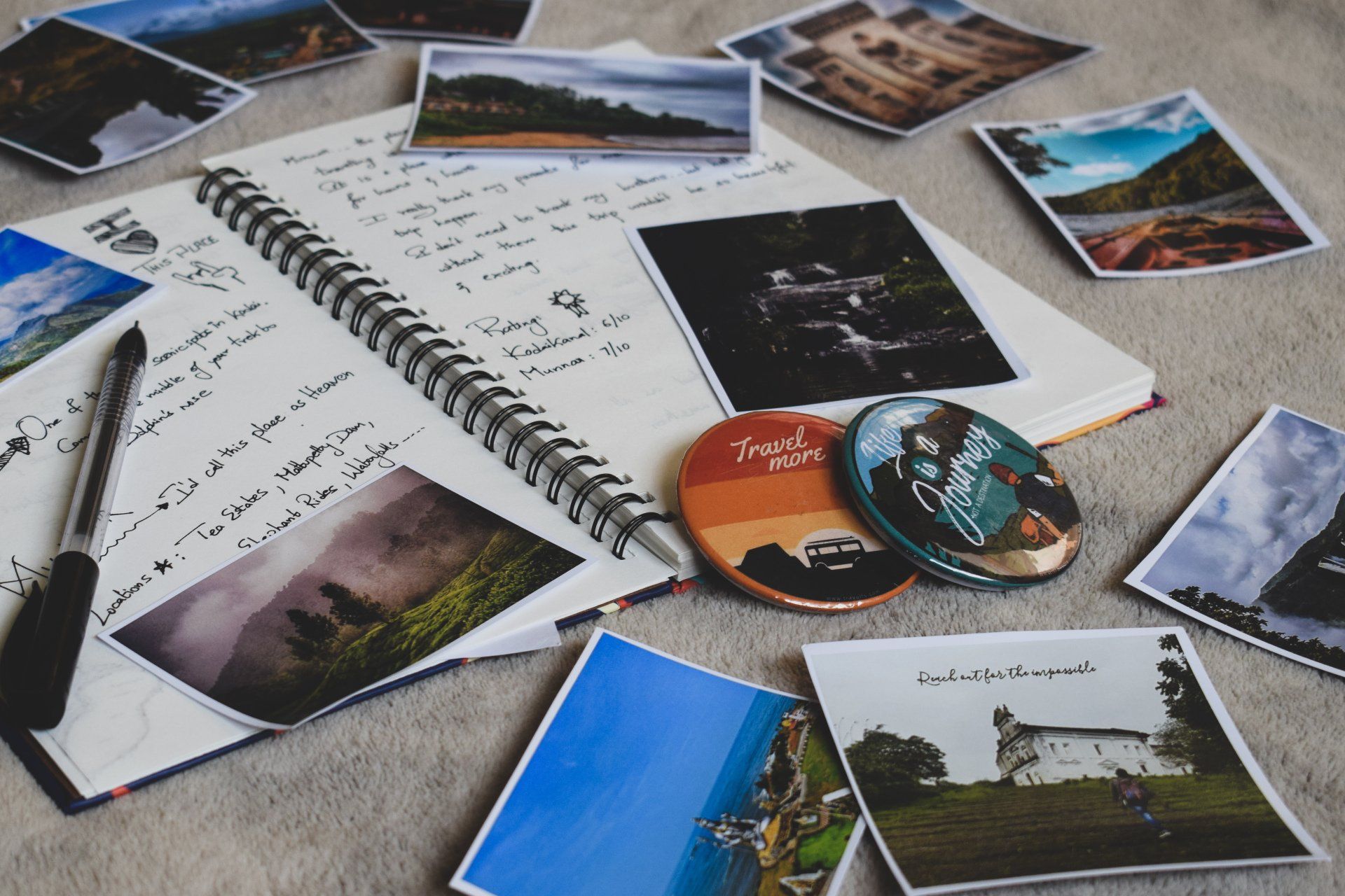 A notebook with a pen and a bunch of pictures on it