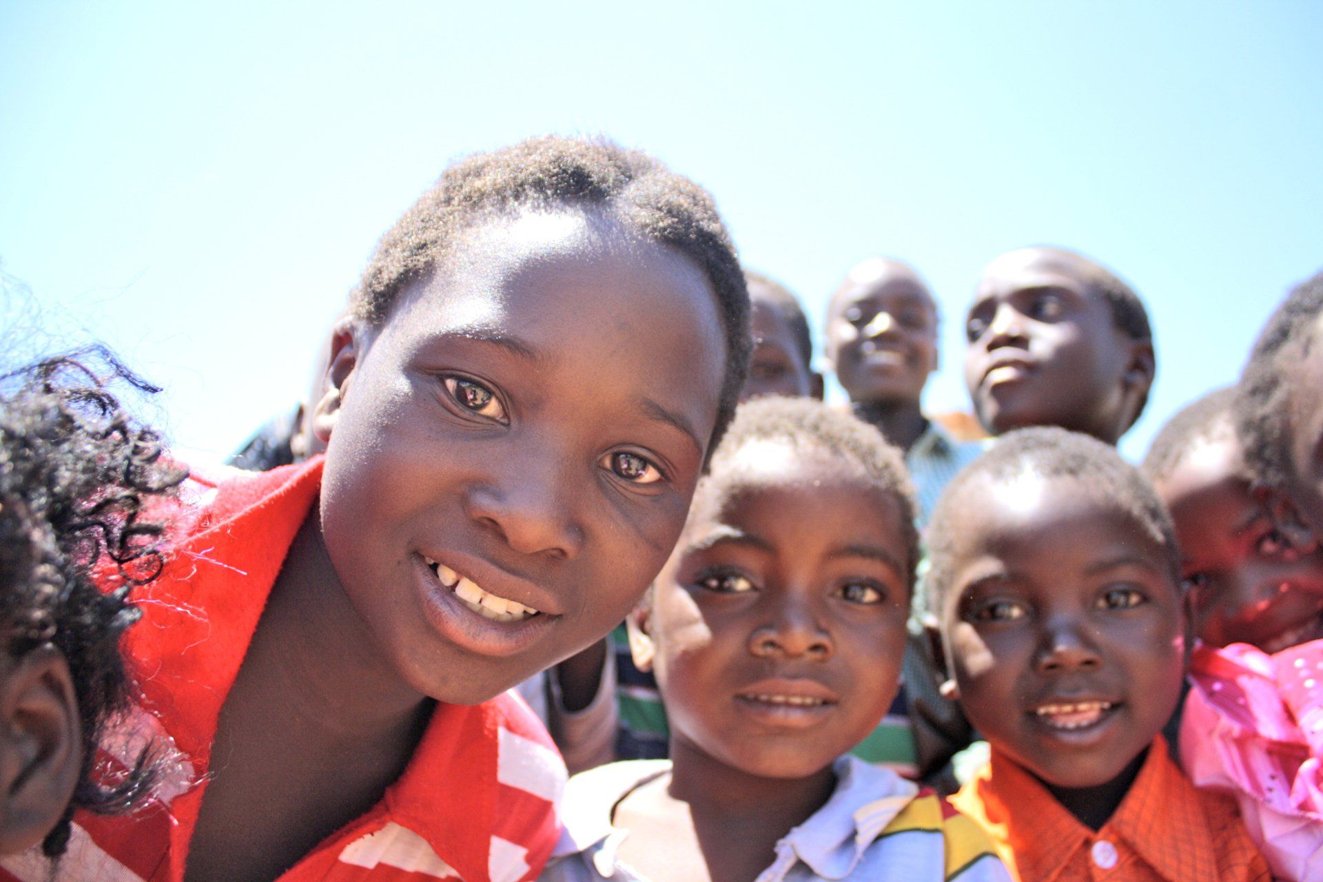 A group of children are posing for a picture and smiling