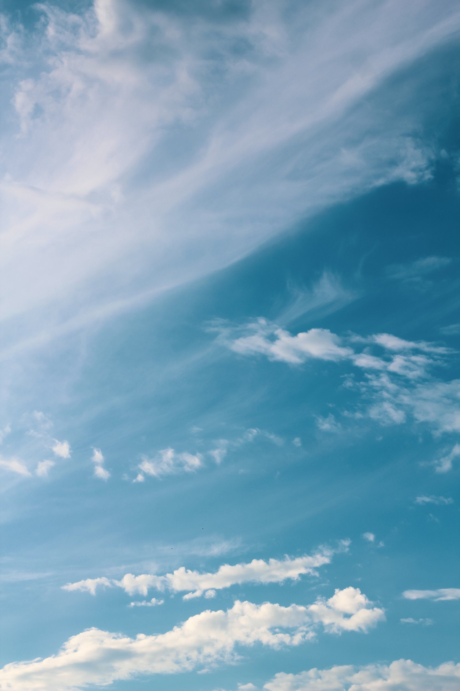 A blue sky with white clouds in it
