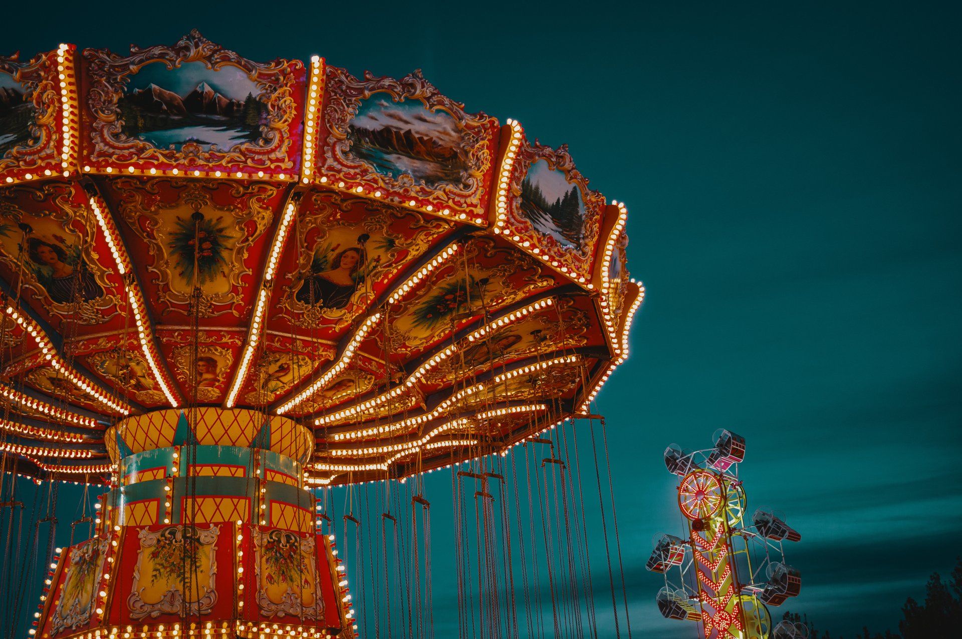 A merry go round at an amusement park at night.
