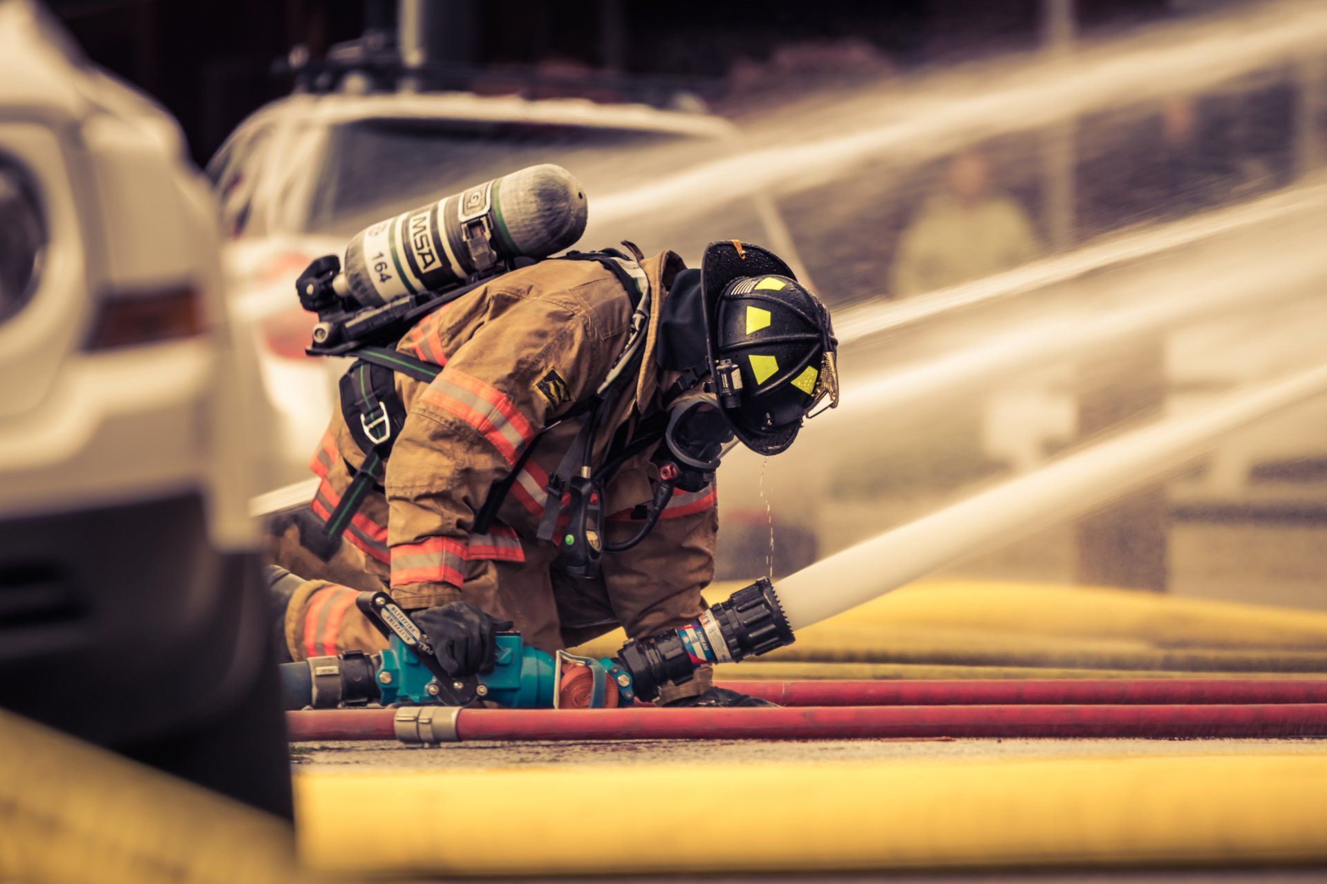 Photos of a fireman, hand washing station, and portable toilets