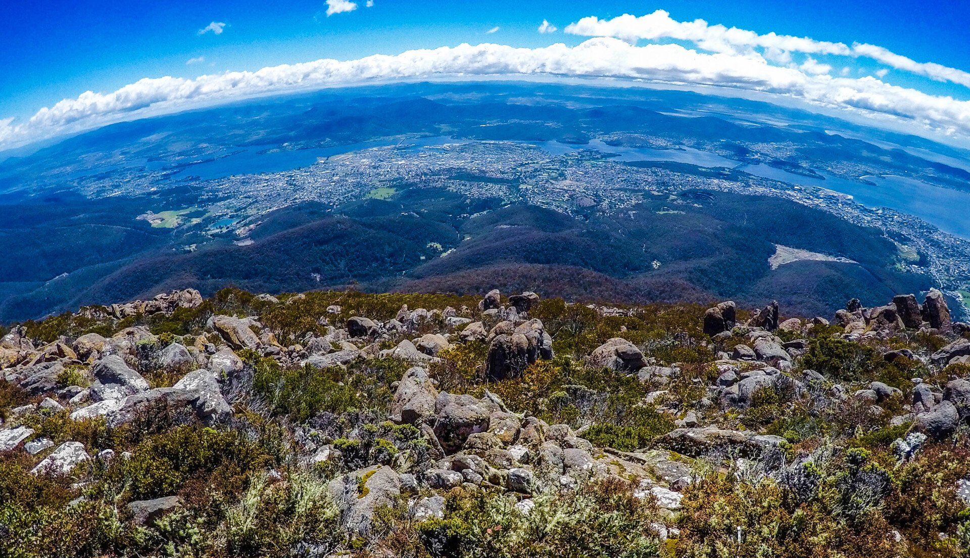 A view of a city from the top of a mountain.