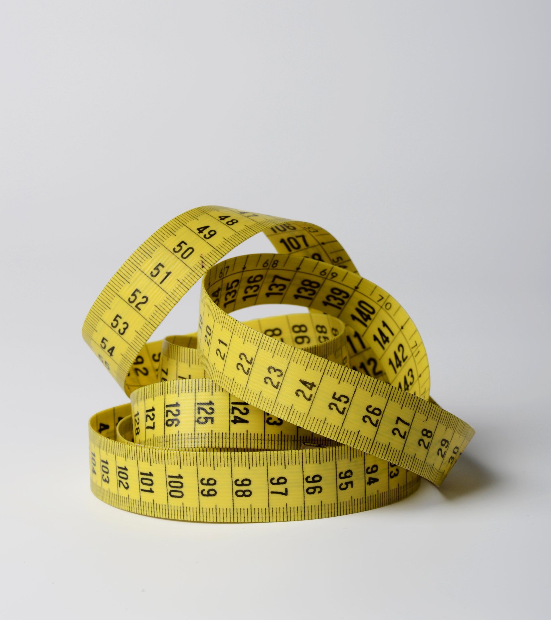 A yellow measuring tape with the numbers 1 through 12 on it