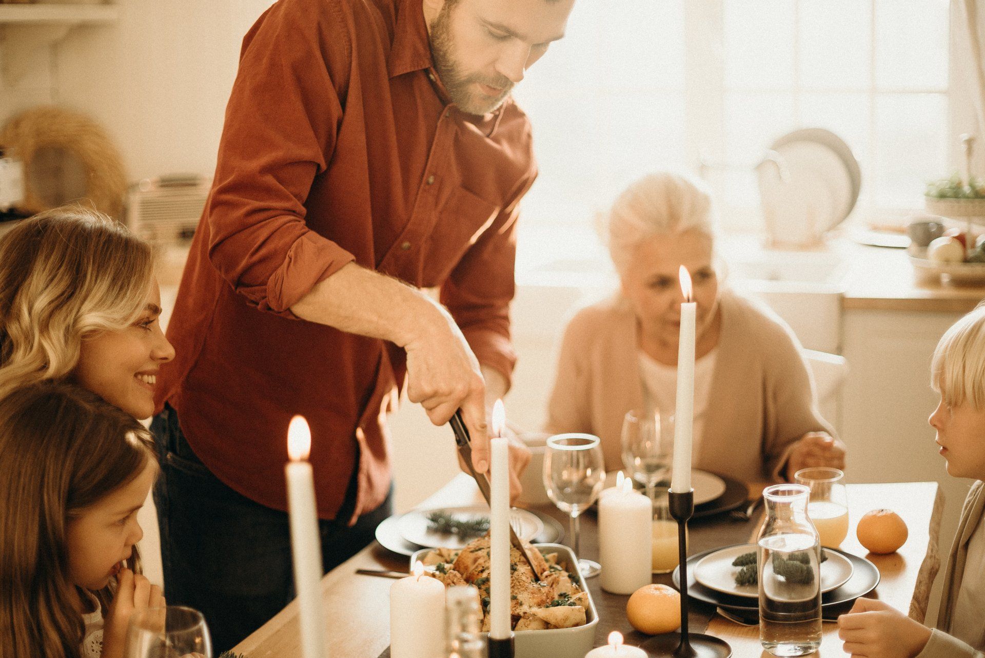 man cutting dinner to serve to family