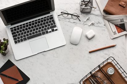 Photo of desk with laptop and work accessories