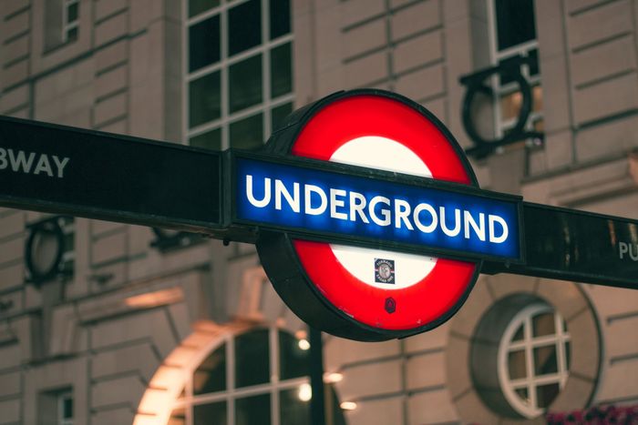 A sign that says underground on it in front of a building