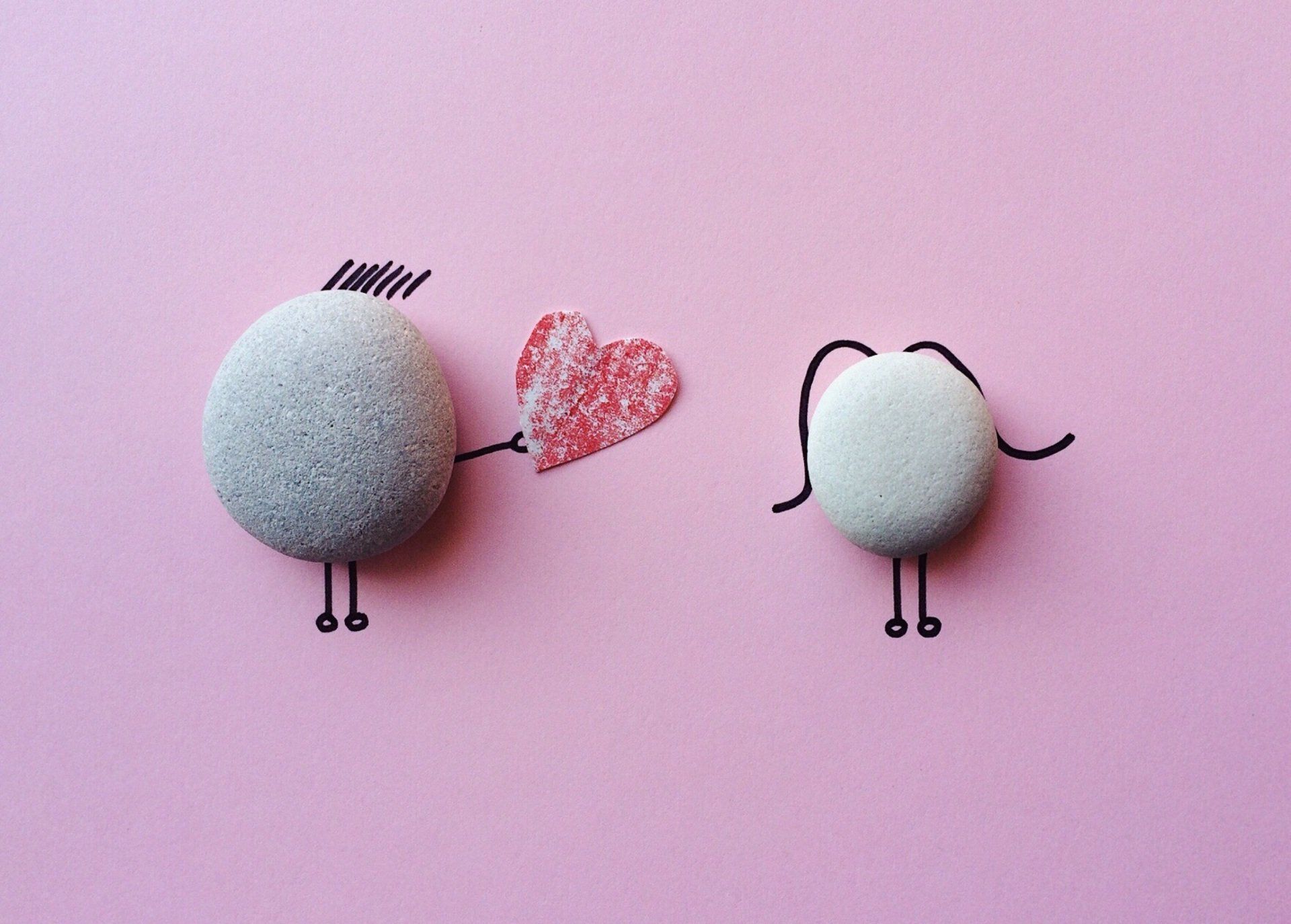 Pebble characters drawn to show once pebble giving a heart to another