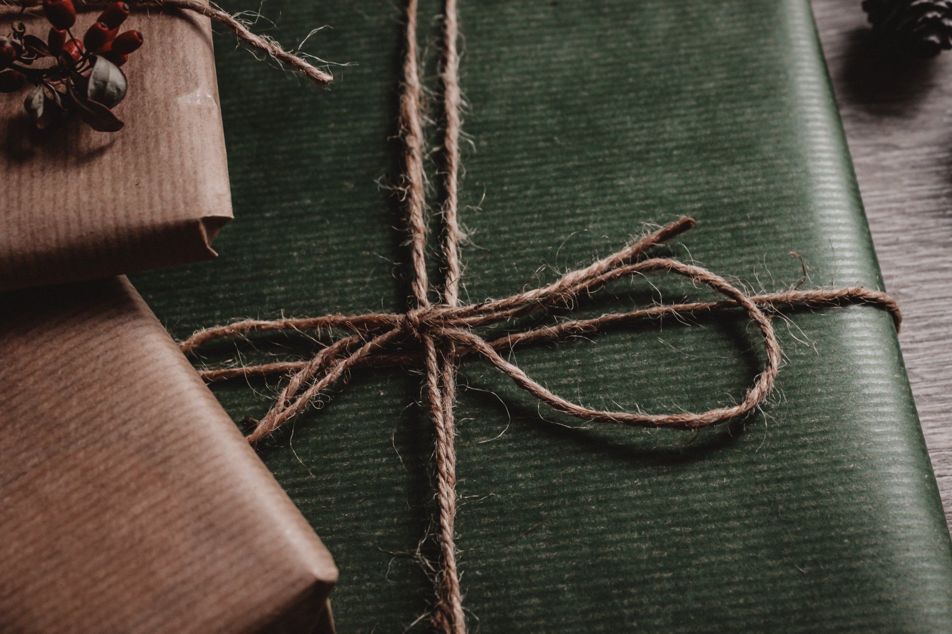 a close up of a gift wrapped in green paper and tied with string .