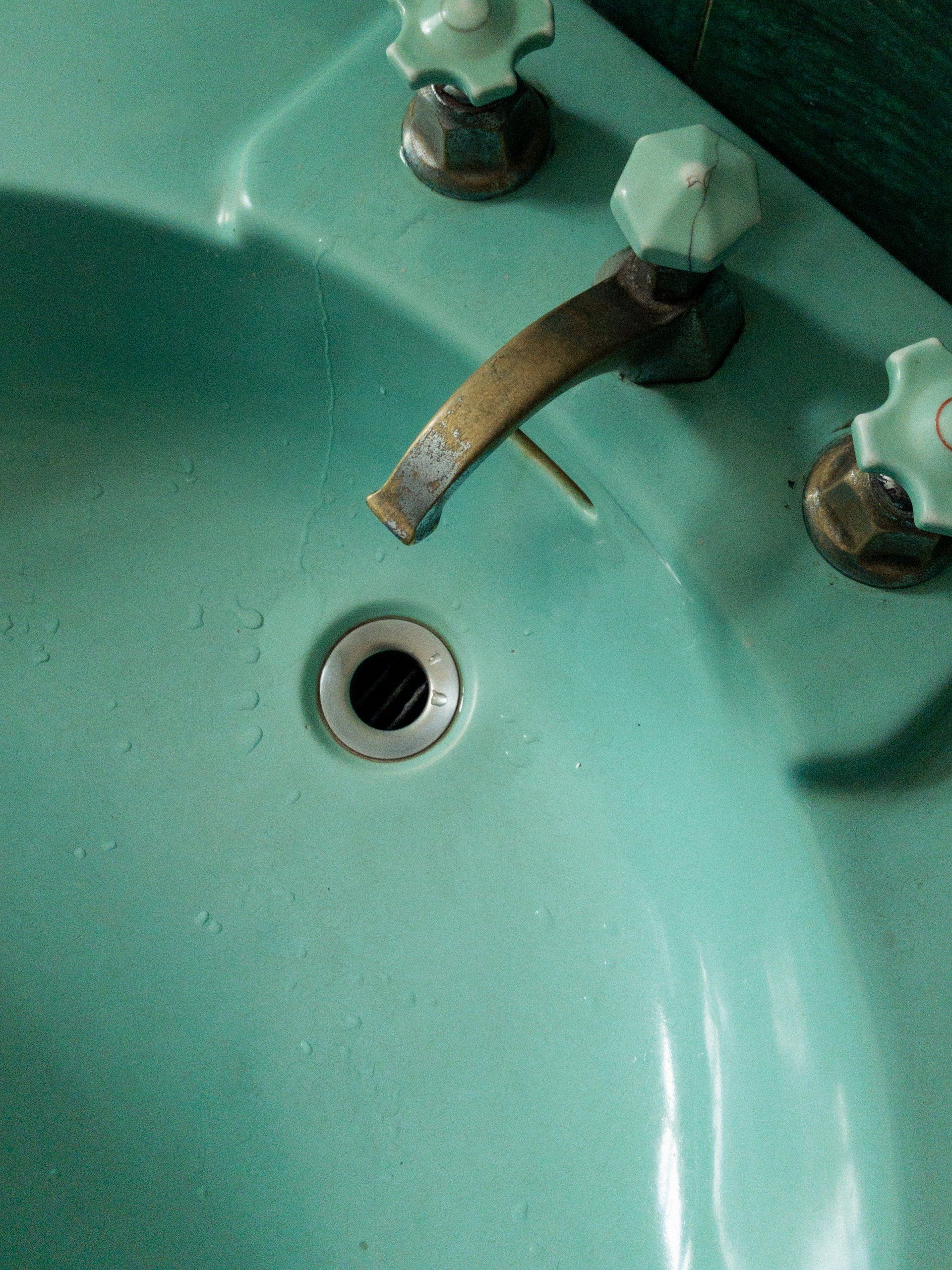 a plumber is fixing a sink in a kitchen