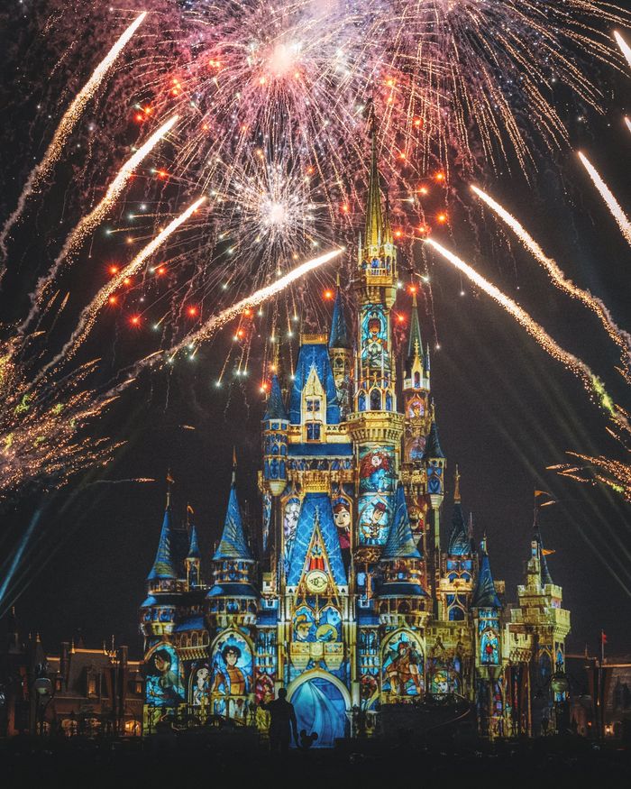 A fireworks display over a castle at night