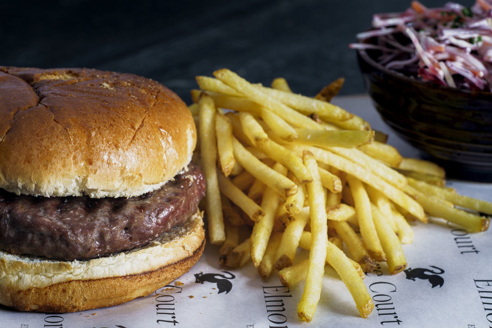 a hamburger and french fries are sitting on a table .