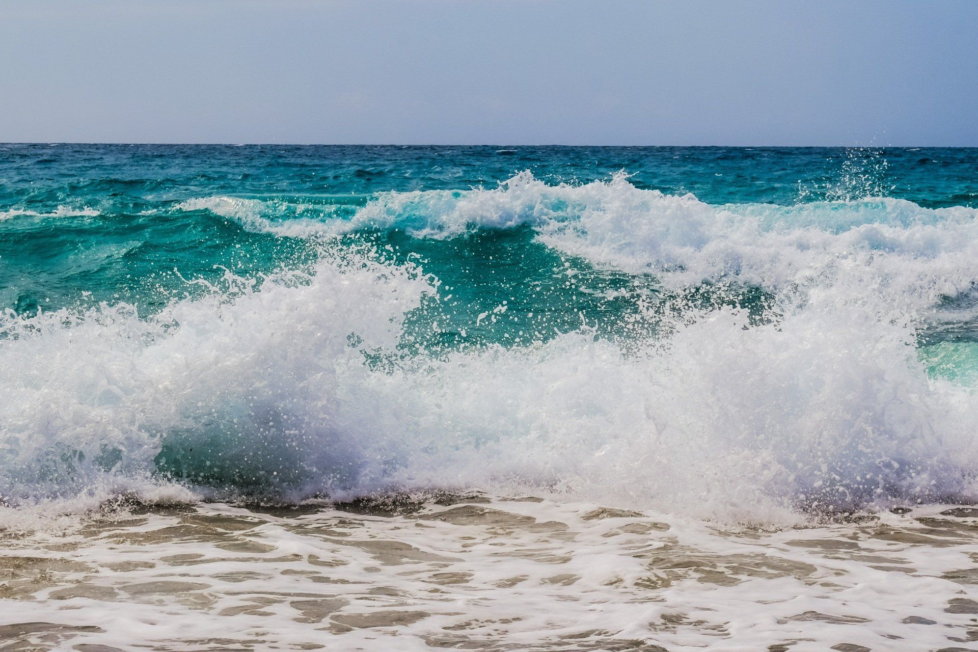 A close up of waves crashing on a beach