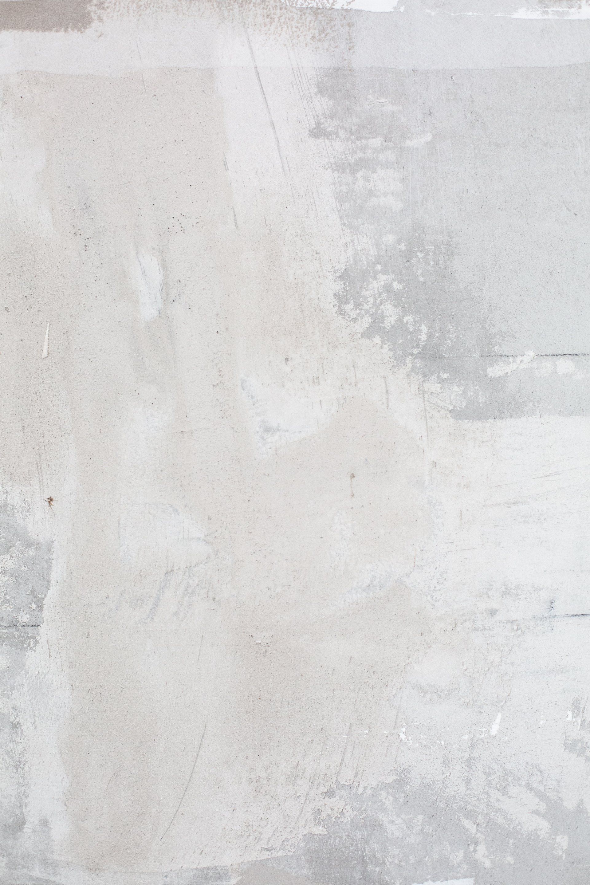 a white wall with a few spots of paint on it