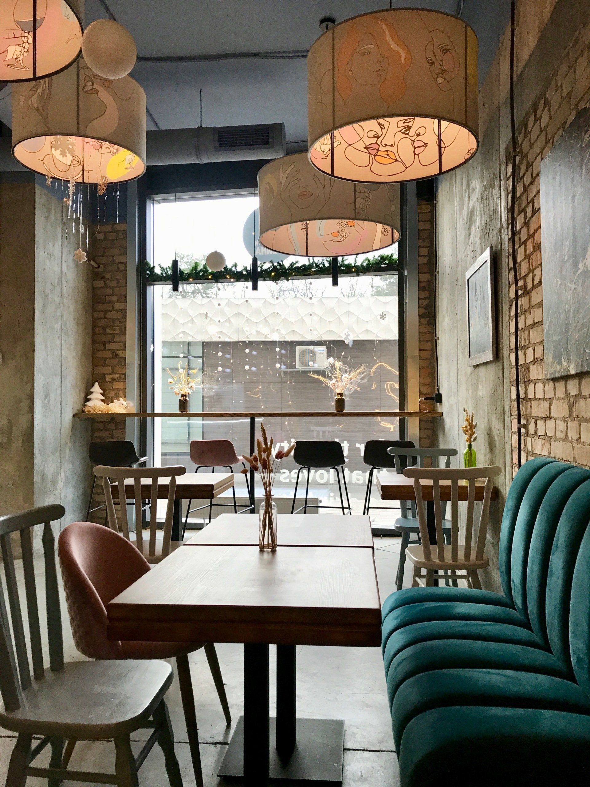 A restaurant with tables and chairs and a blue couch