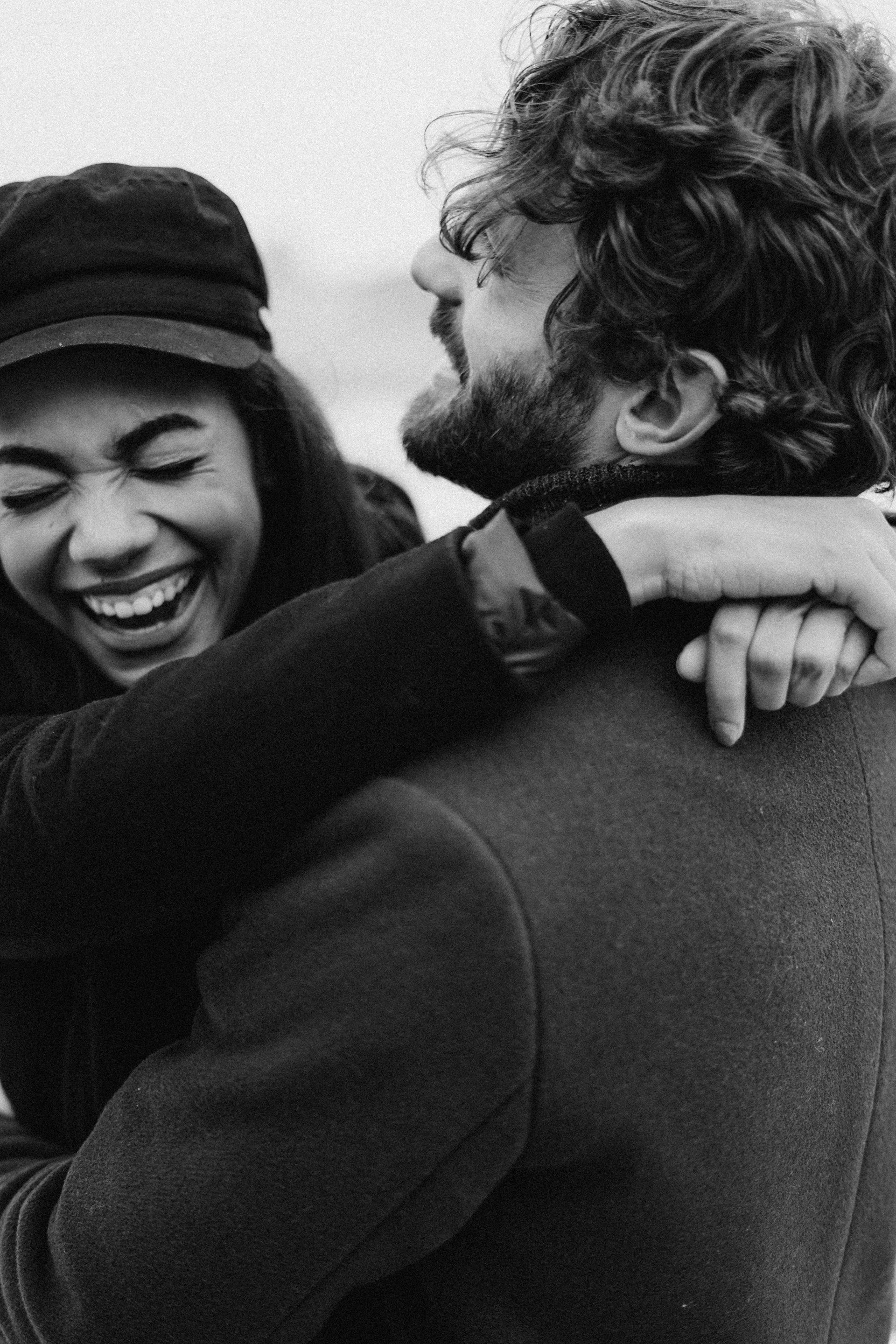 COUPLE LAUGHING AND HUGING