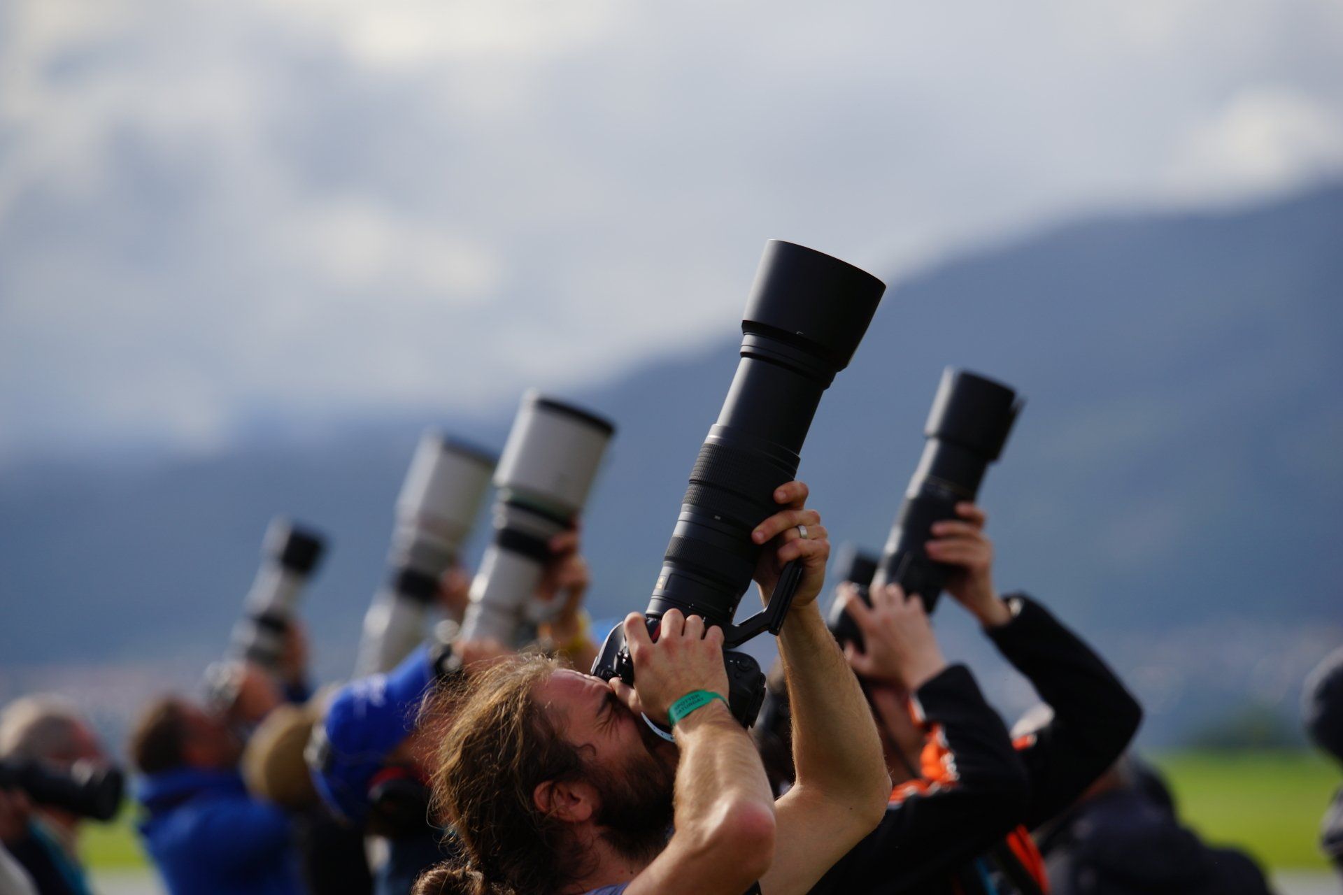 A group of people are taking pictures with their cameras