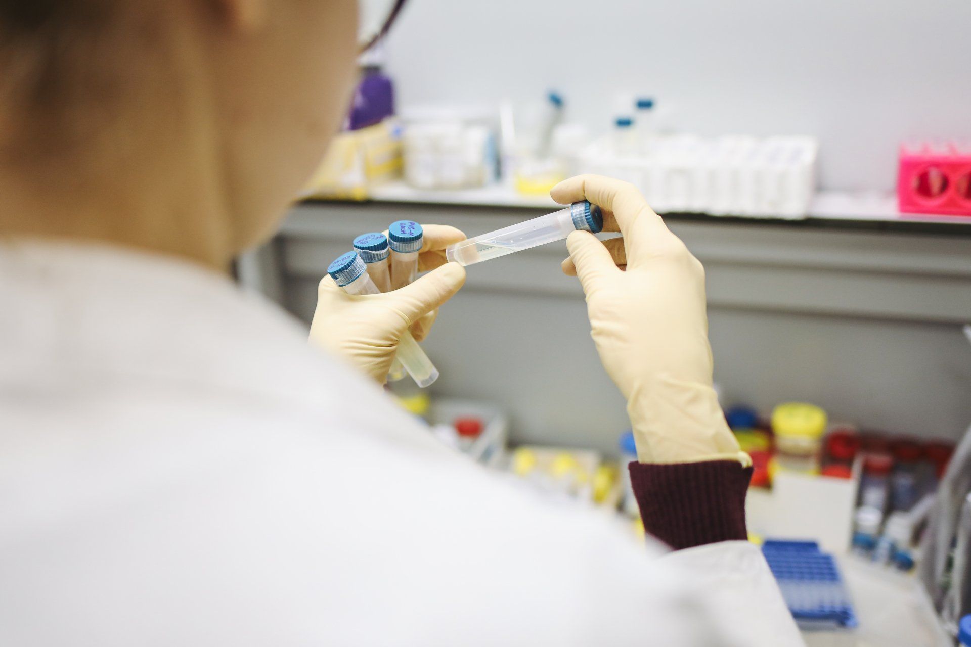 A scientist is holding a test tube in a laboratory.