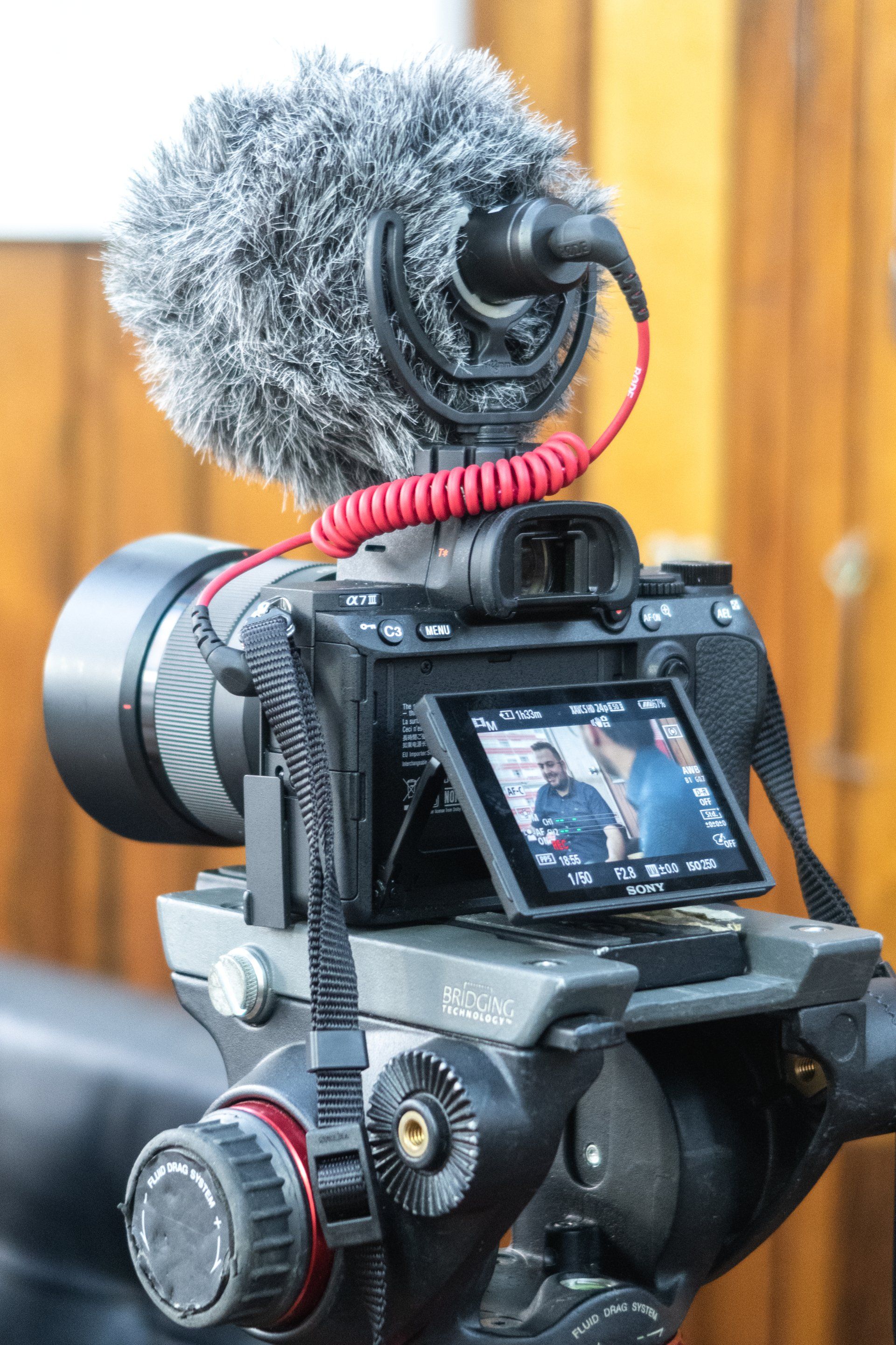 a camera with a microphone attached to it is on a tripod .