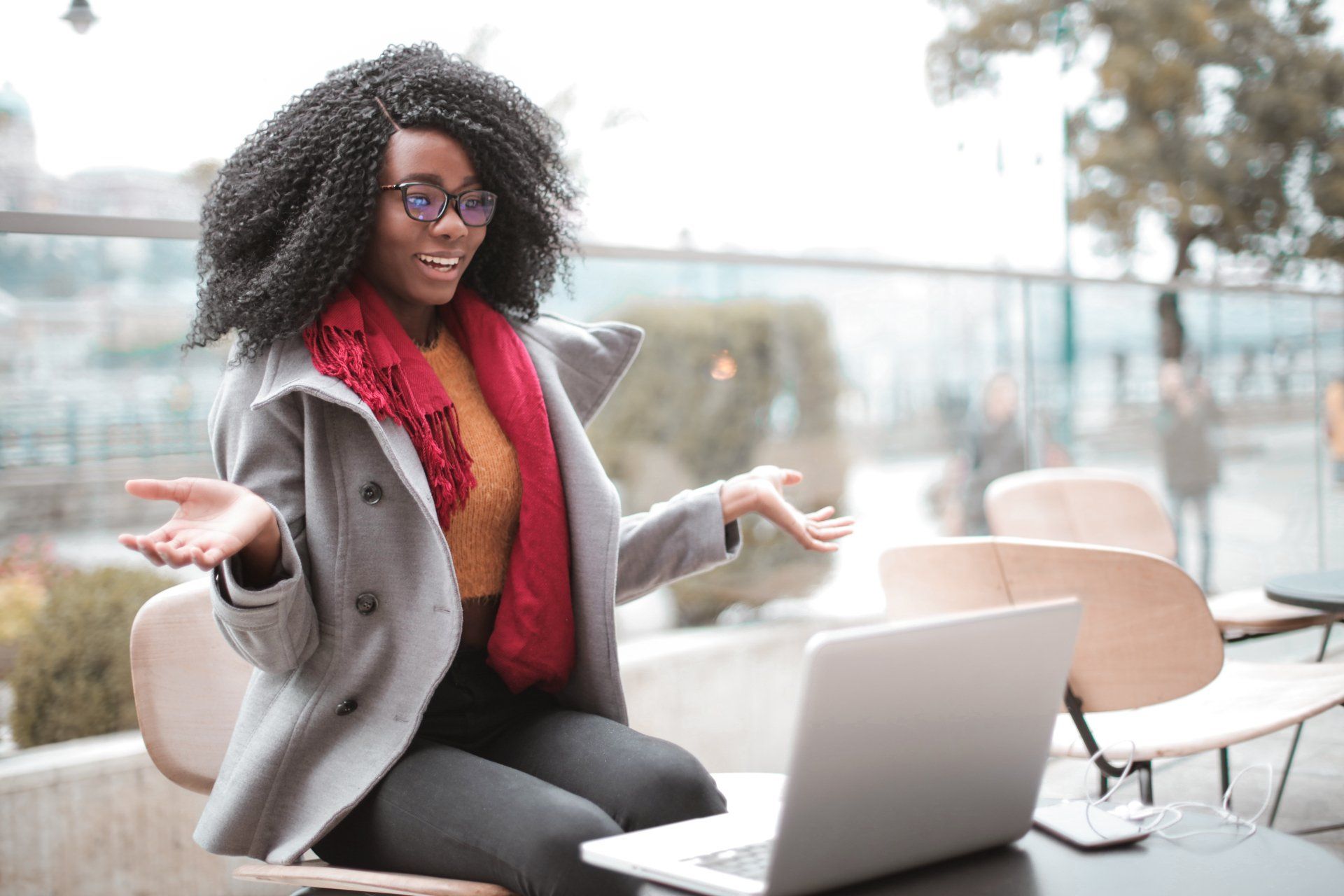 A woman is sitting at a table with a laptop computer.