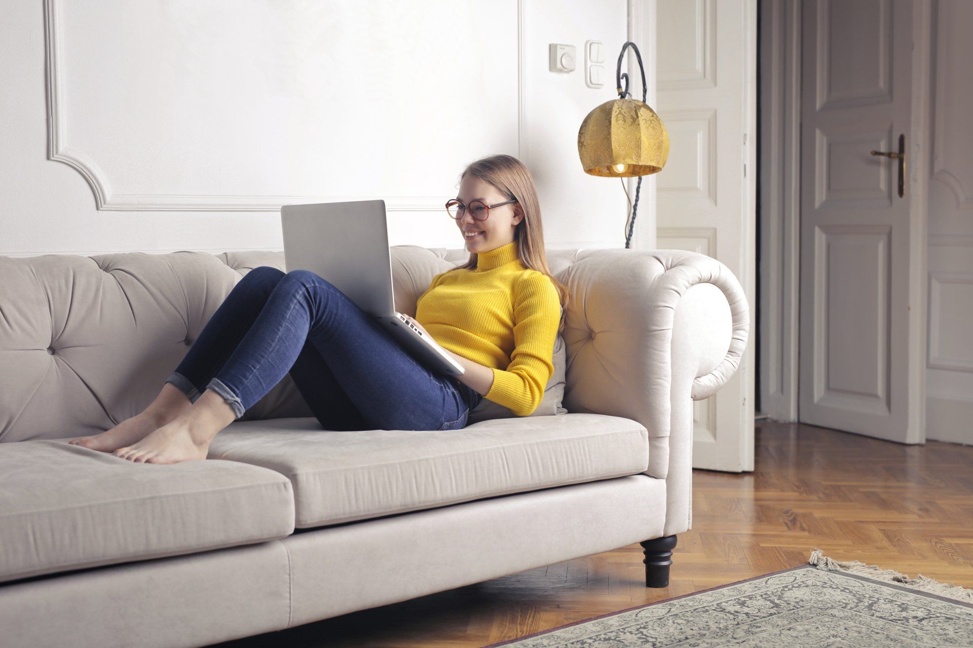 lady on couch browsing on computer