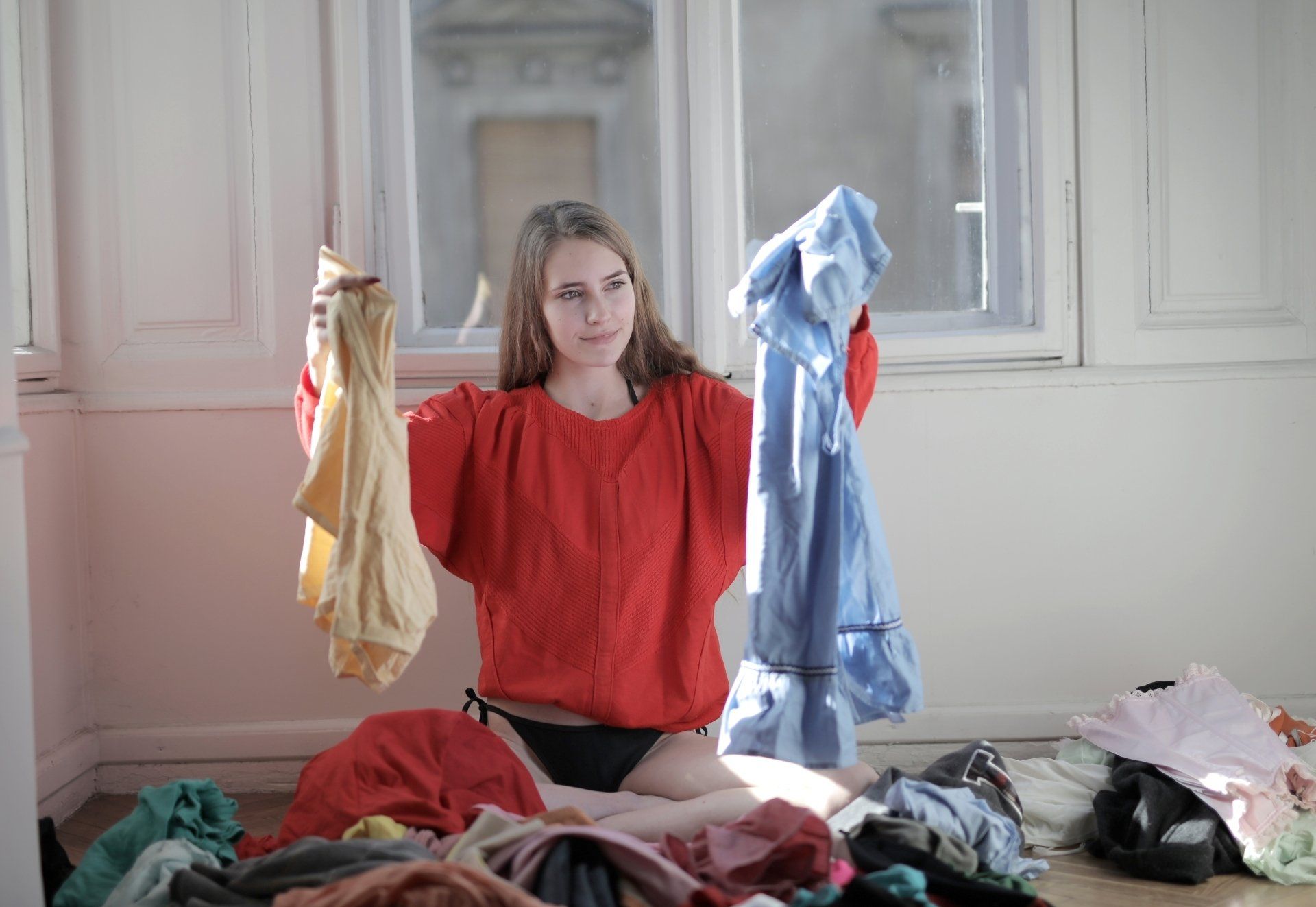 a woman holding some laundry