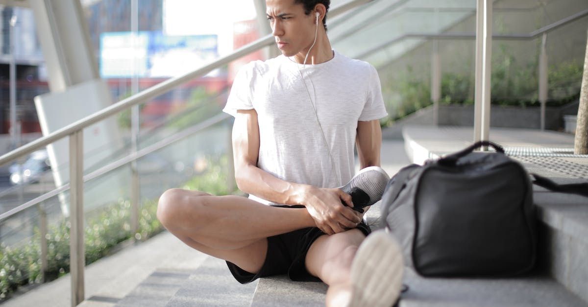 Young male sitting and stretching, free from sciatic nerve pain