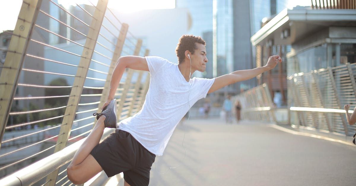 Man stretching before running, without any neck pain.