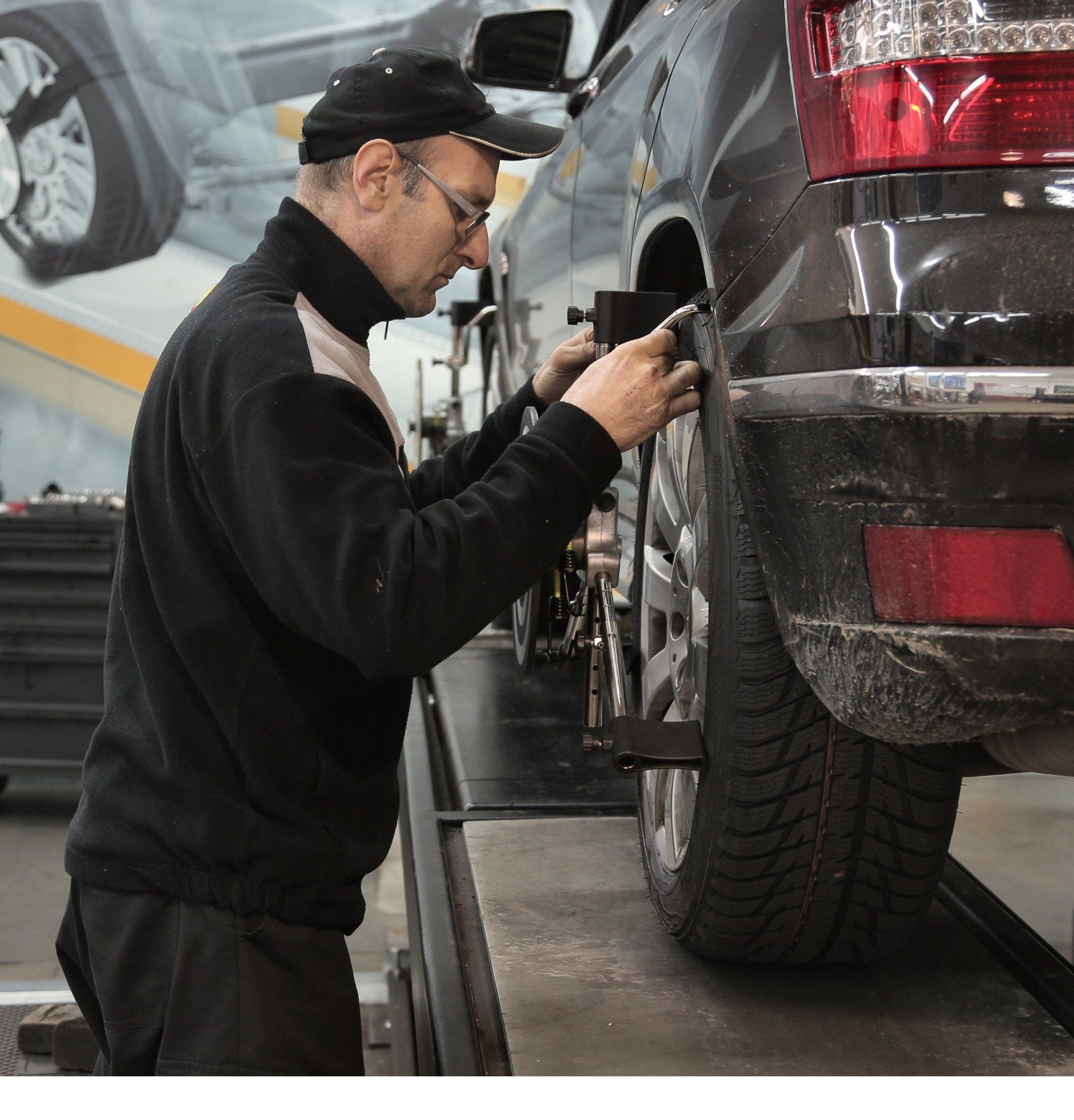 Professional Mechanic Performing Alignment Adjustments On A Vehicle Wheel | Kingwood Tire & Automotive