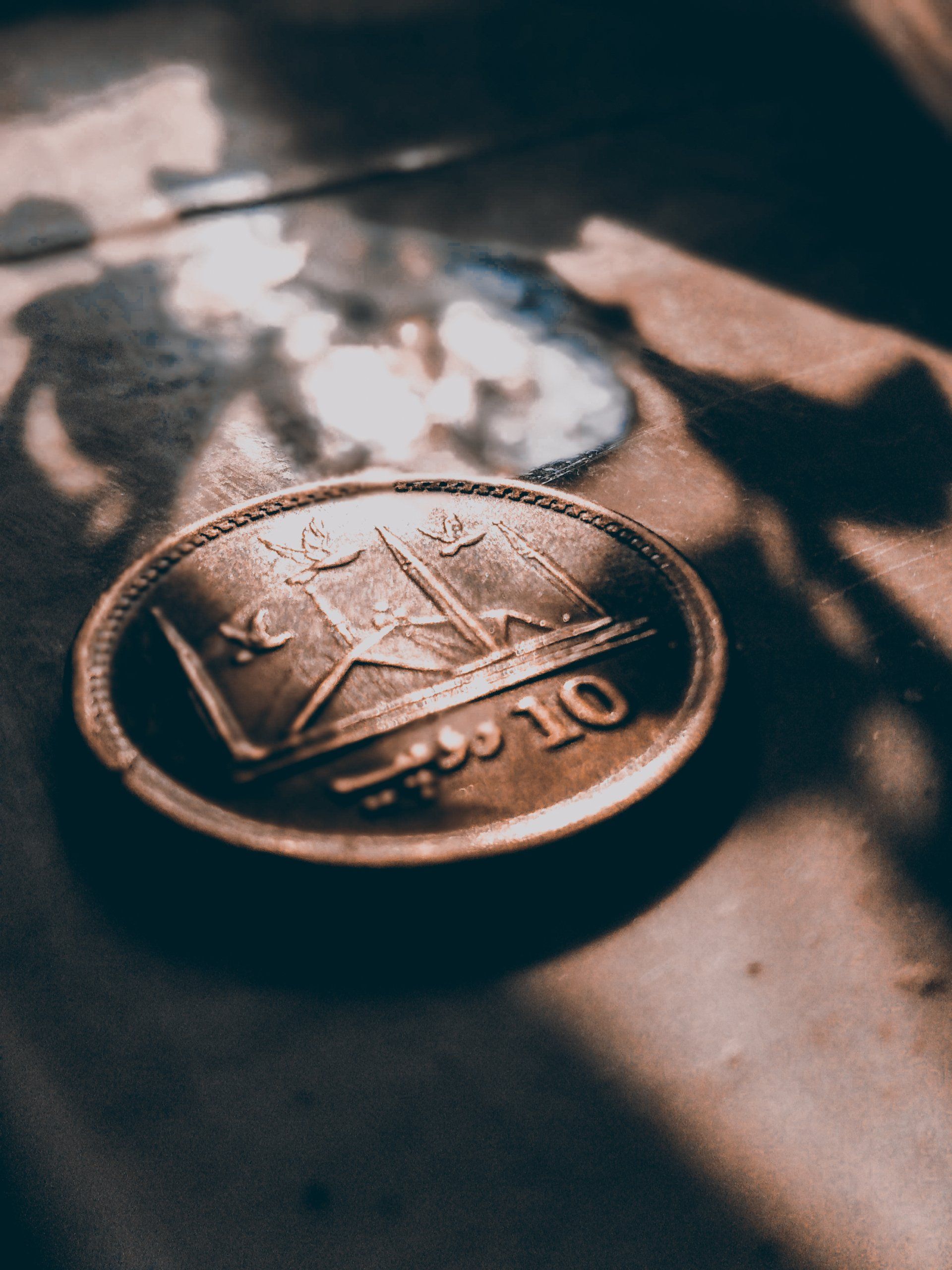 A close up of a coin with the number 10 on it