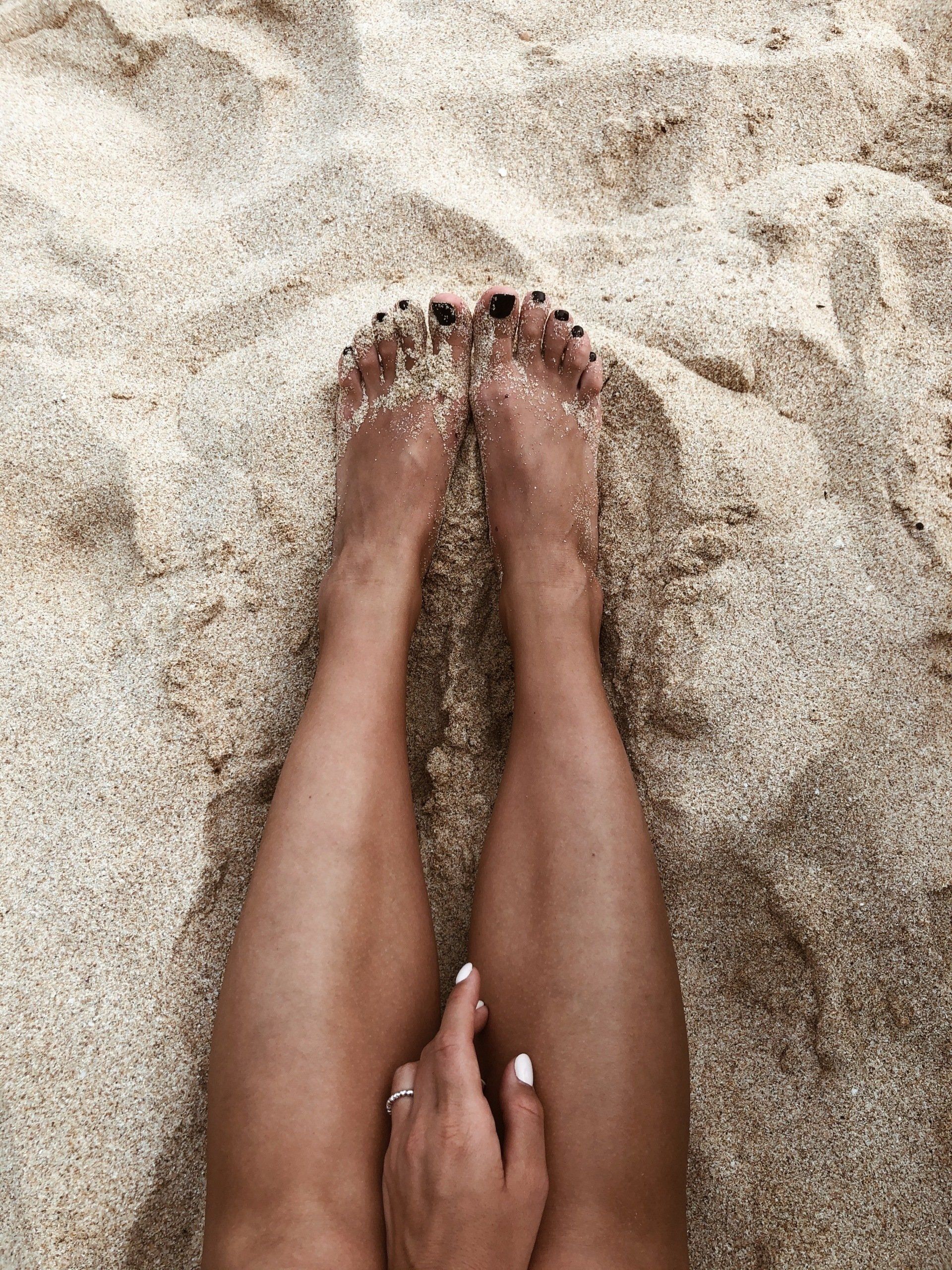 legs in beach sand