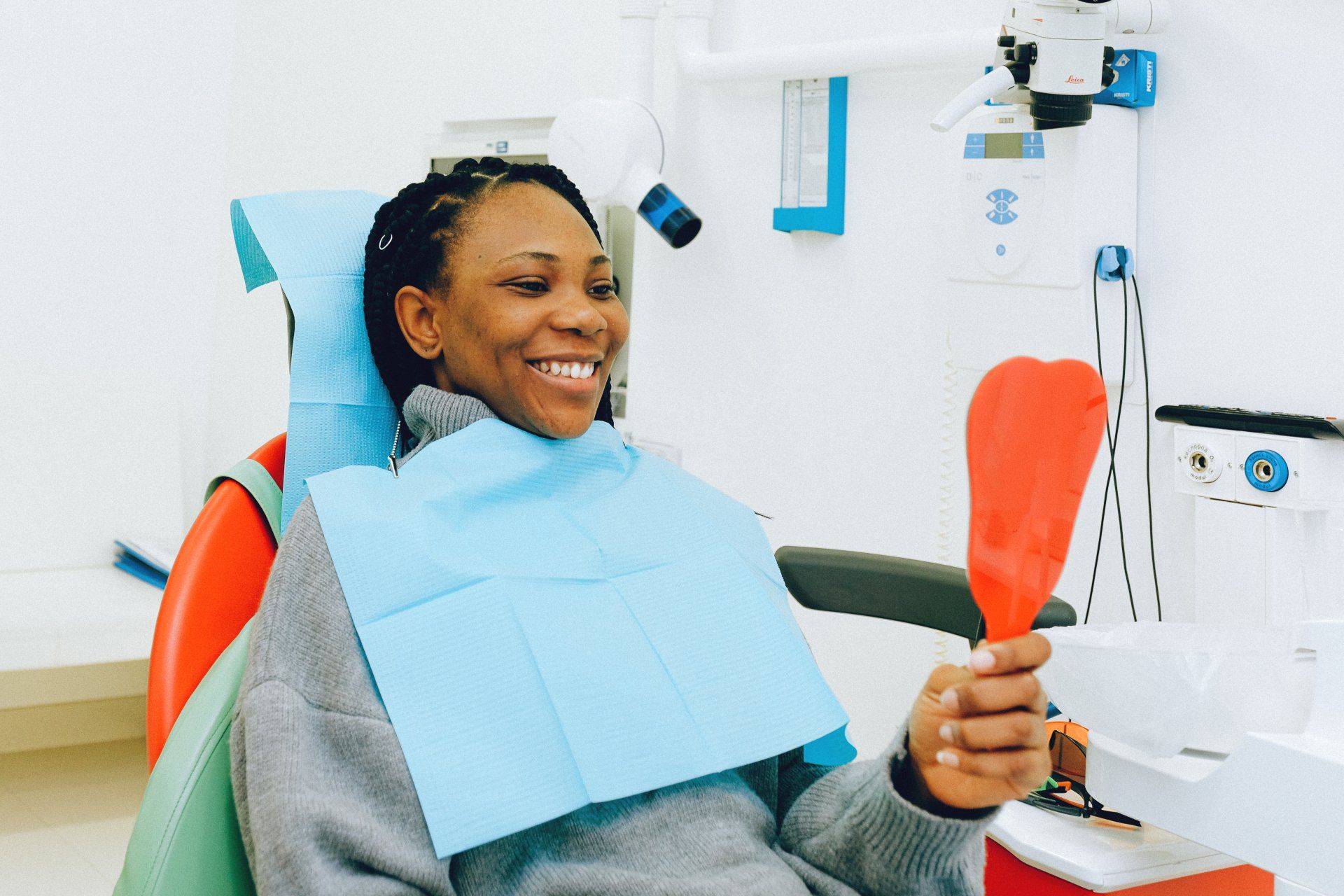 happy patient holding mirror