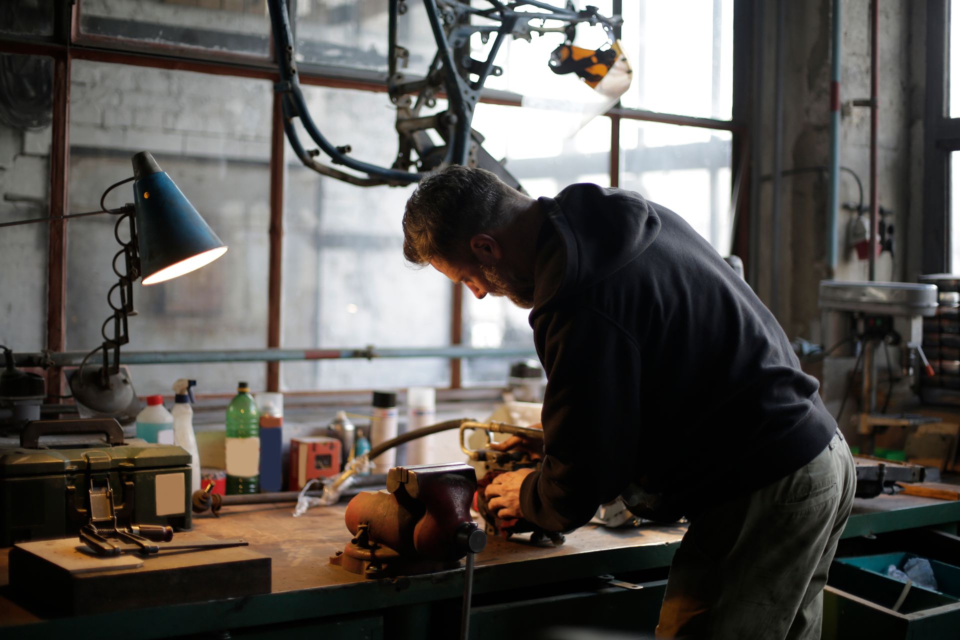 A man is working on a machine in a workshop.