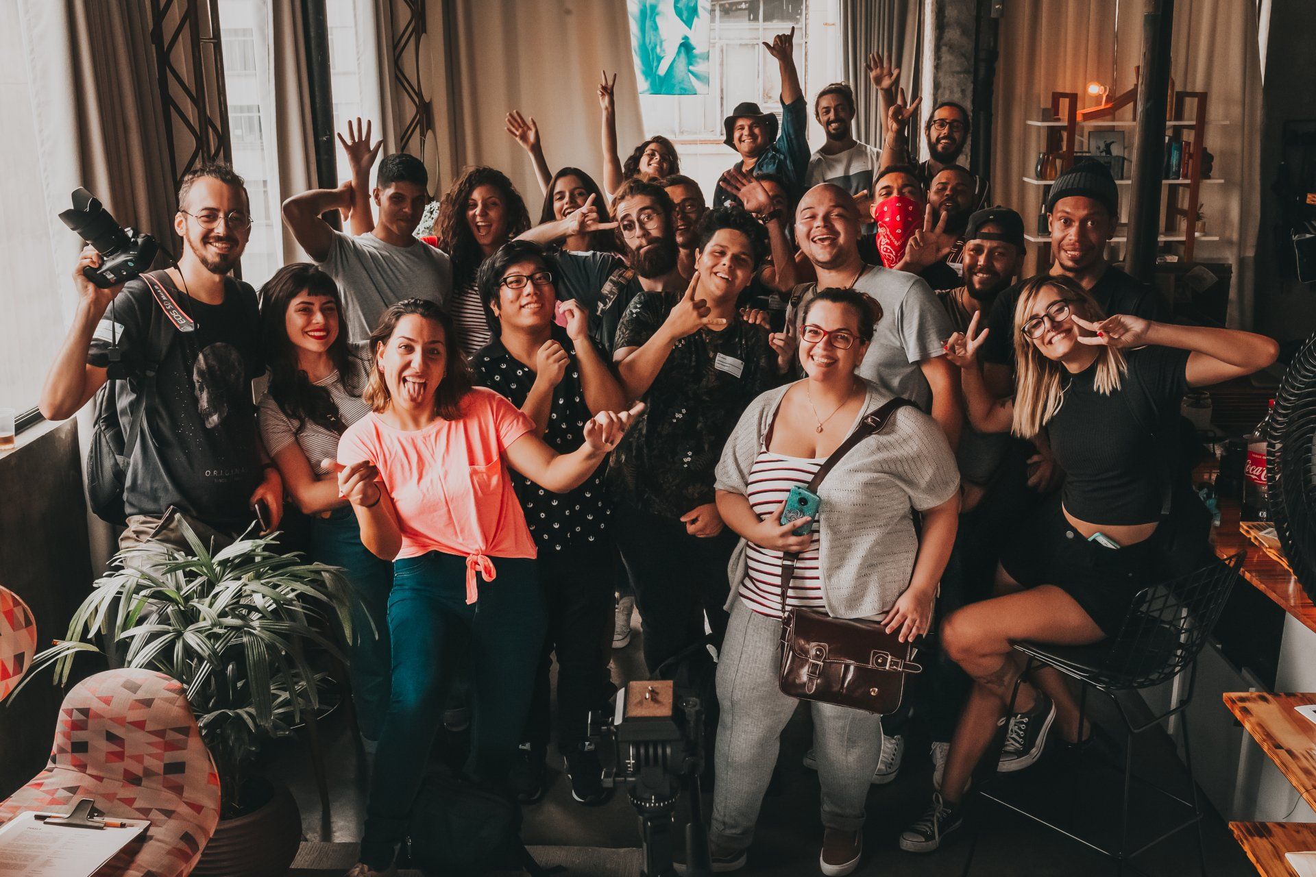 A large group of people are posing for a picture in a room.