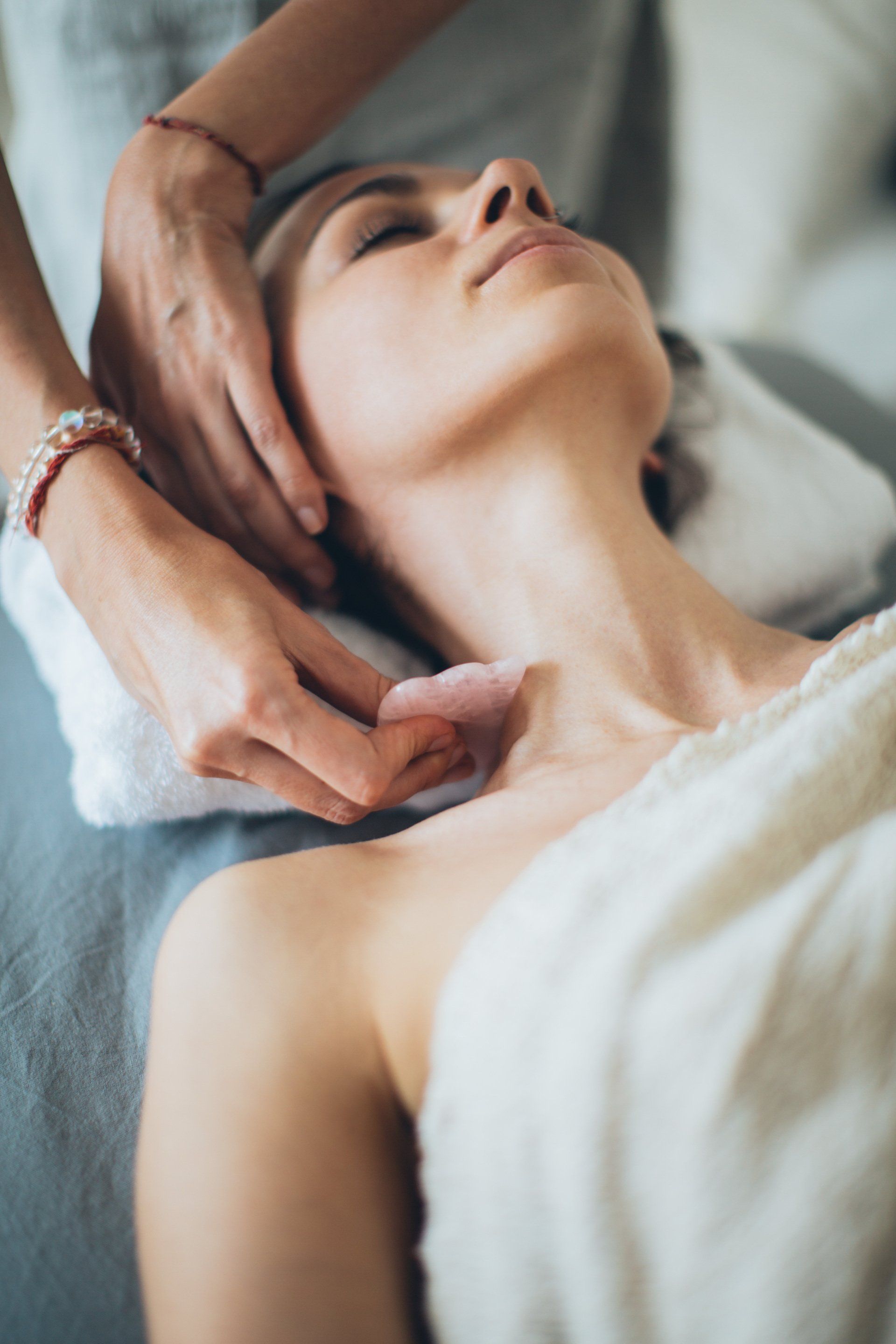 A woman is getting a massage on her face at a spa.