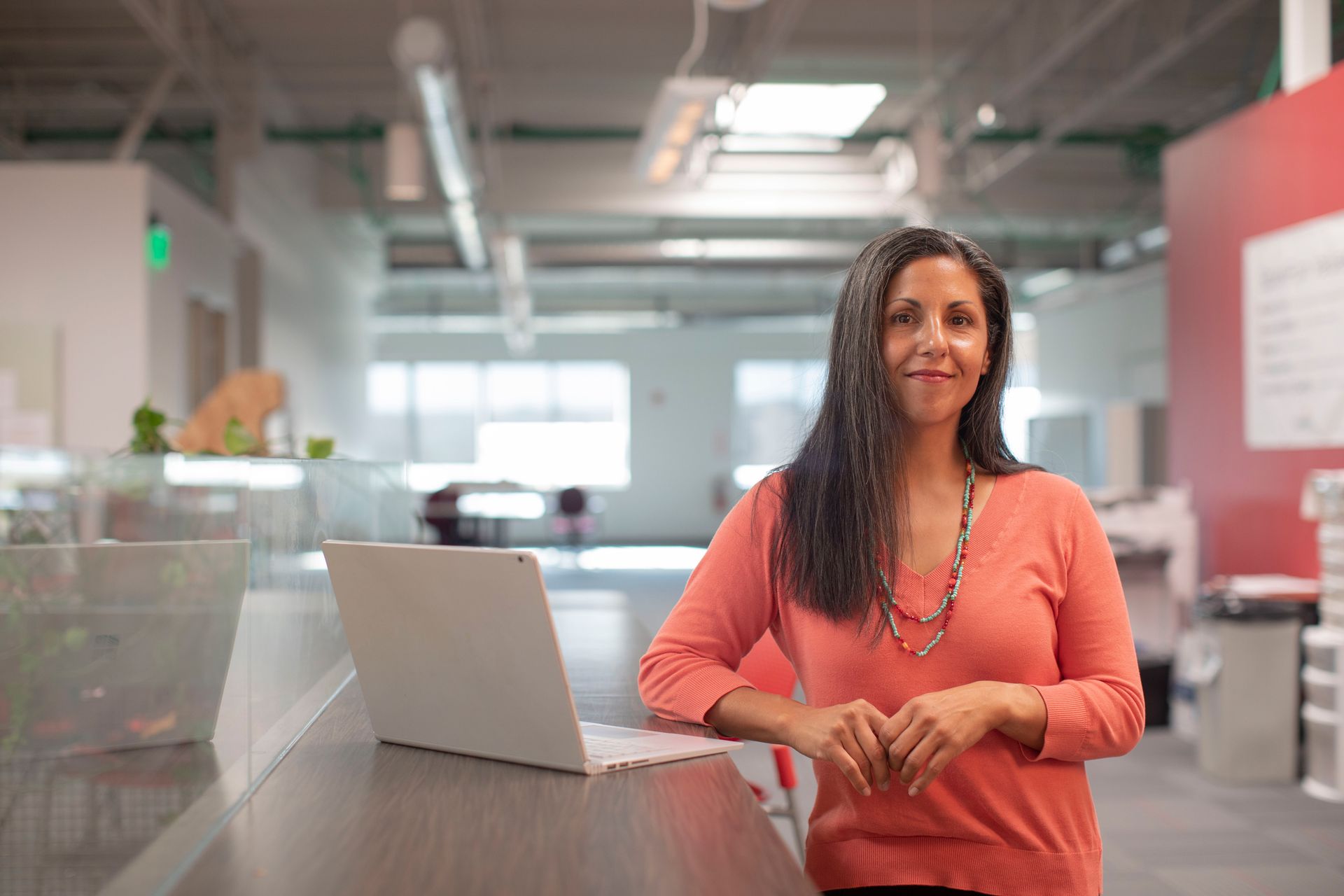 Smiling Tax Professional standing next to laptop