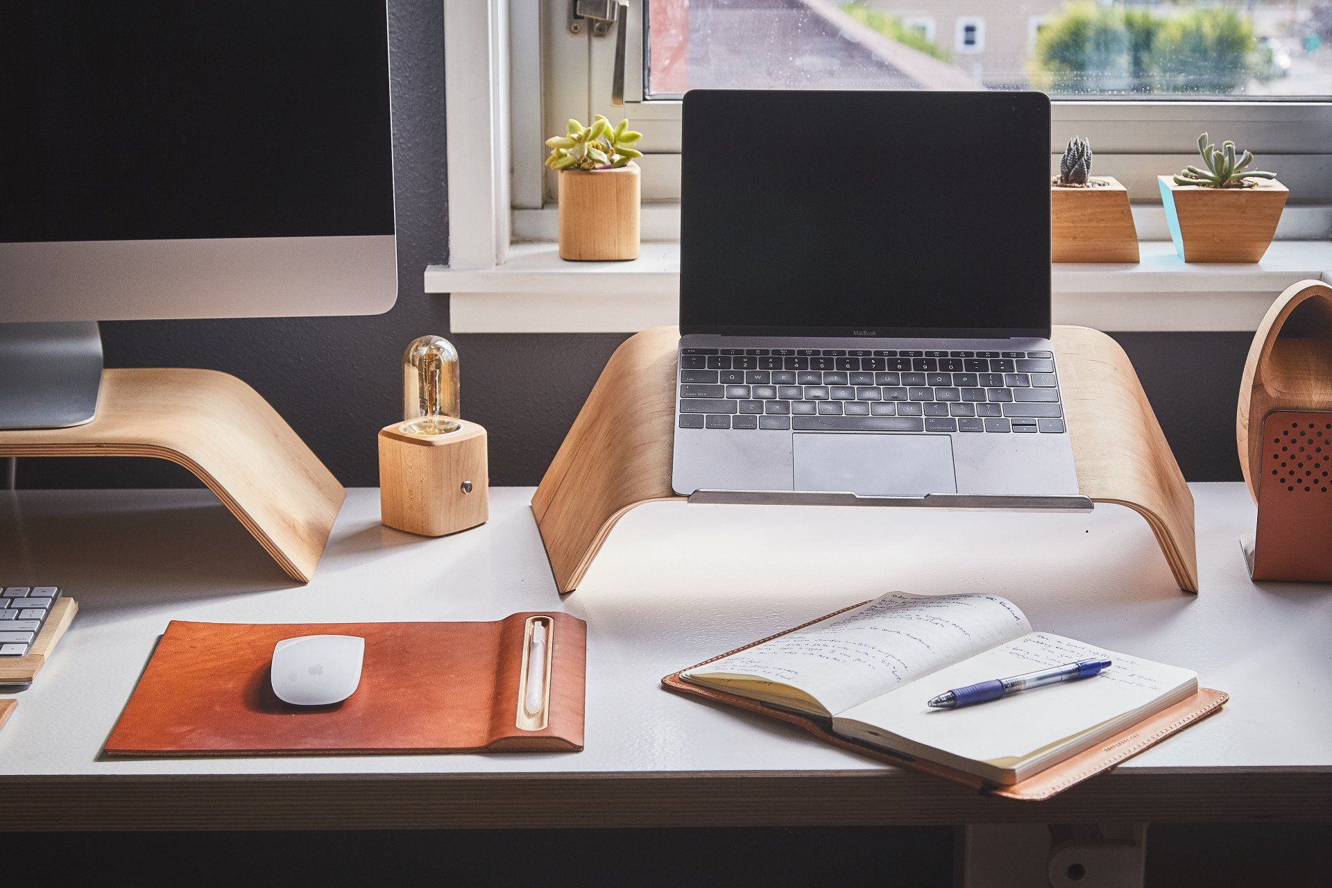 desk with laptop and pen and paper