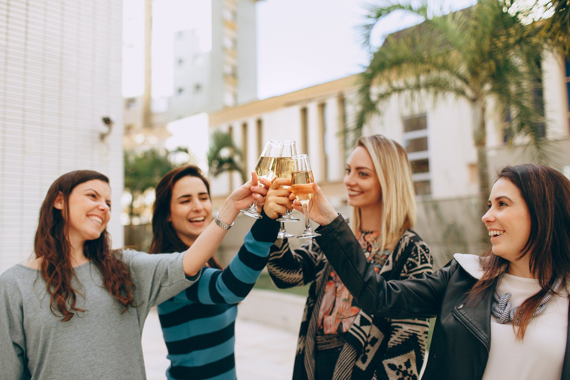 A group of women are toasting with champagne glasses.