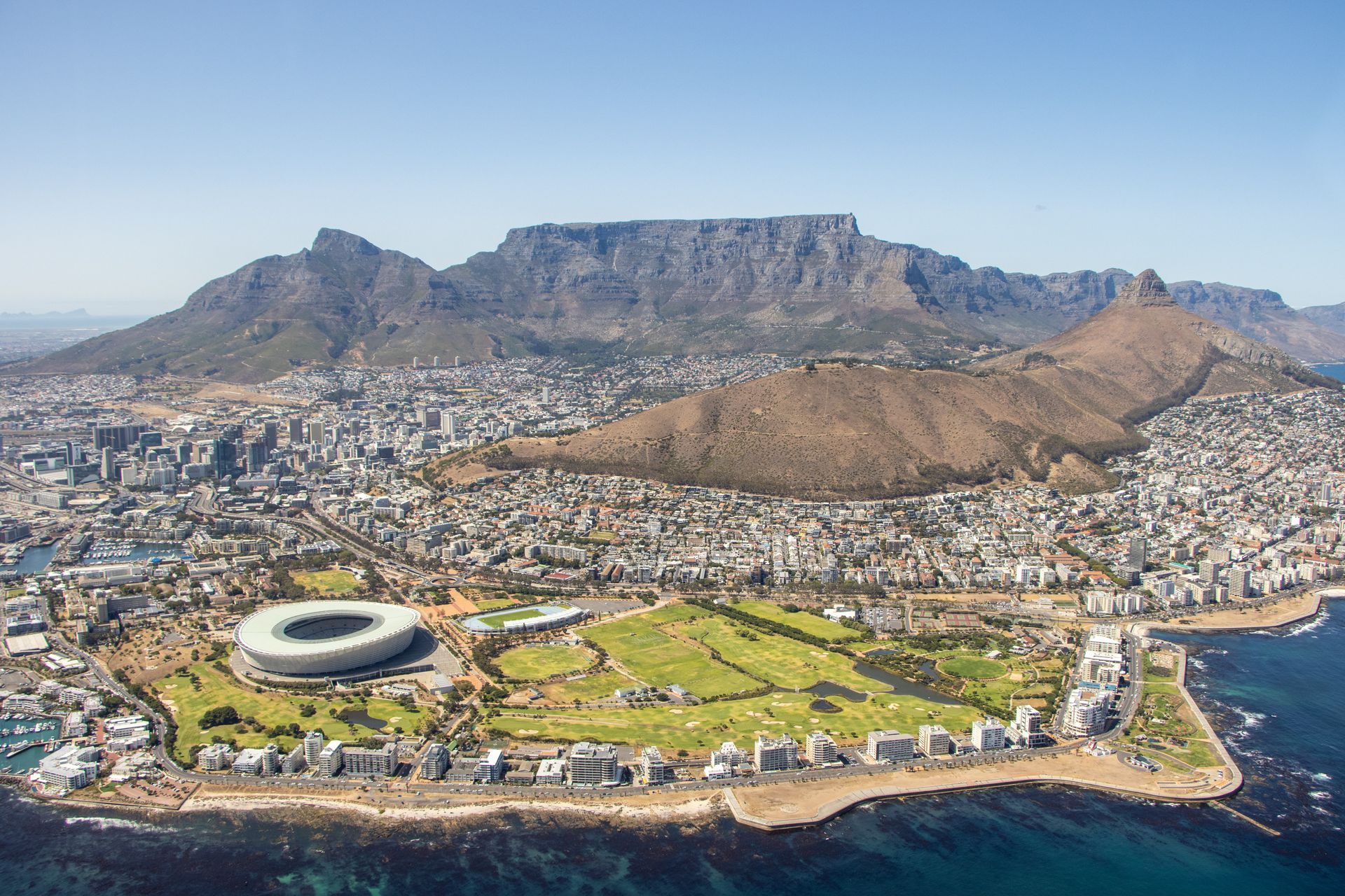 An aerial view of cape town with a mountain in the background.
