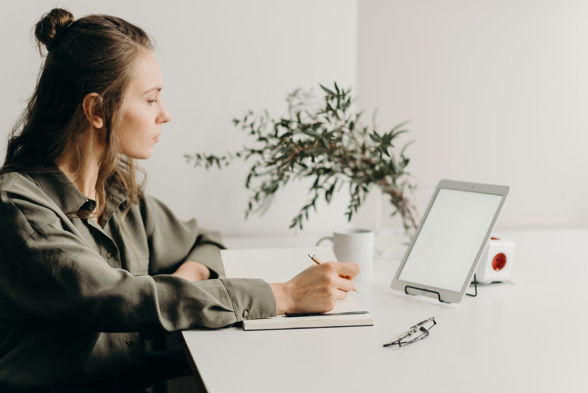 Woman working remotely from her home on her laptop, exemplifying the hybrid work model