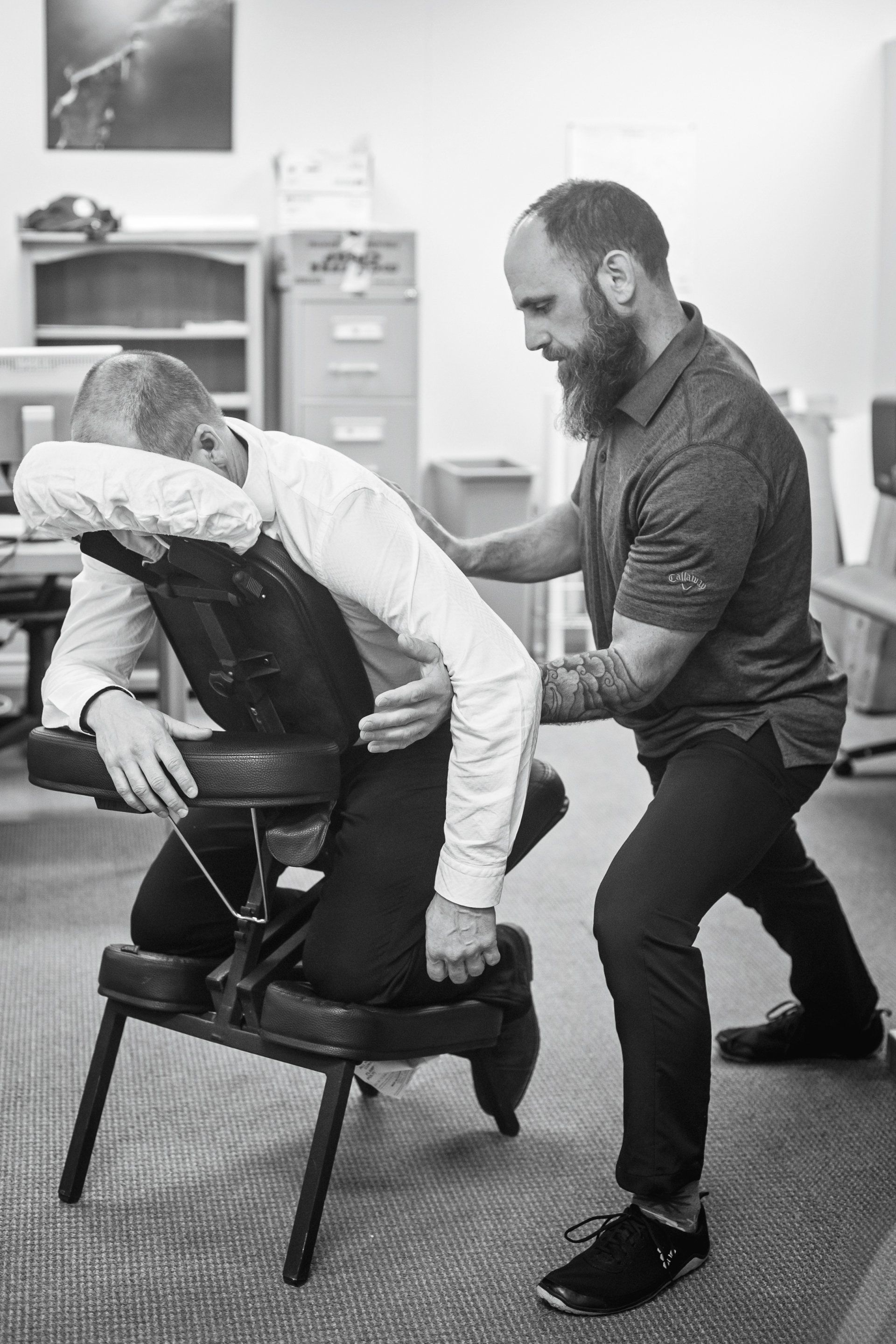 Chiropractor at Buffalo Creek Chiropractic administering a back adjustment to a man on a chiropractic table