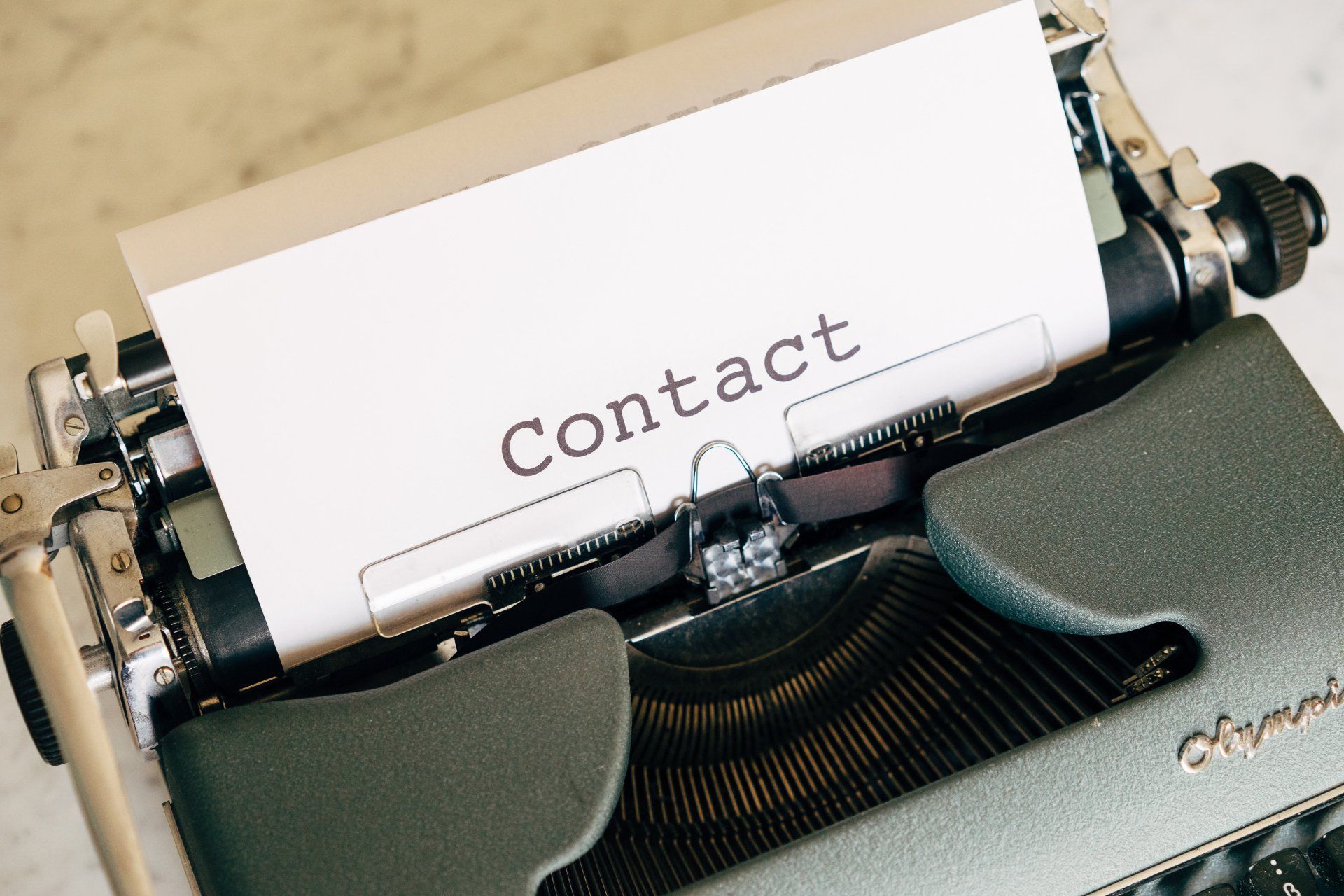 Typewriter with paper displaying the word 