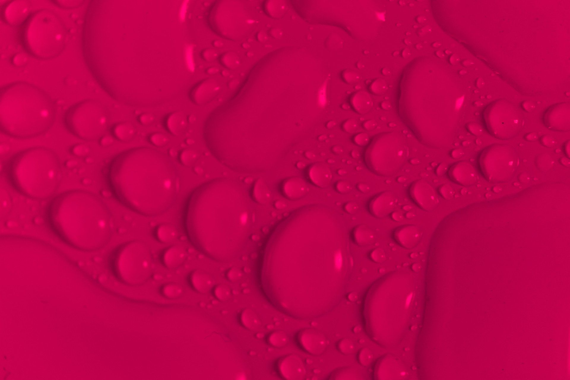 Pink abstract background with translucent water droplets and bubbles