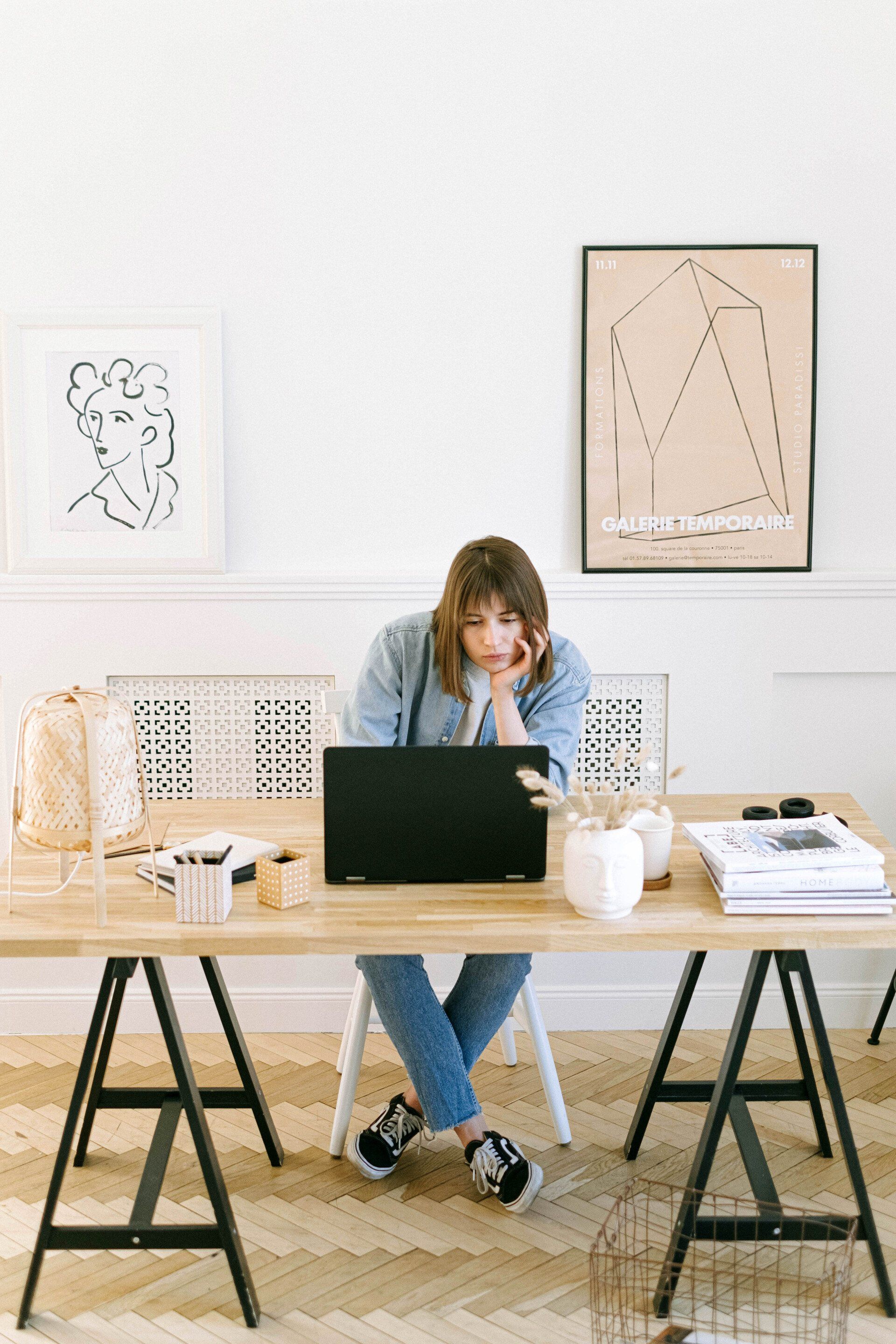 a woman looking at her laptop