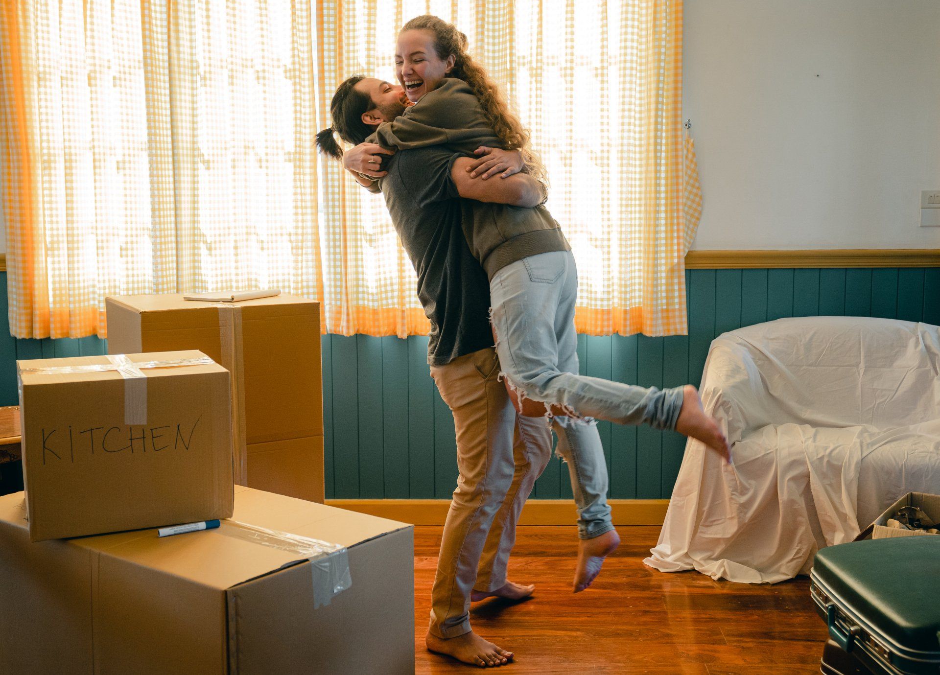 Happy couple hugging in a new home