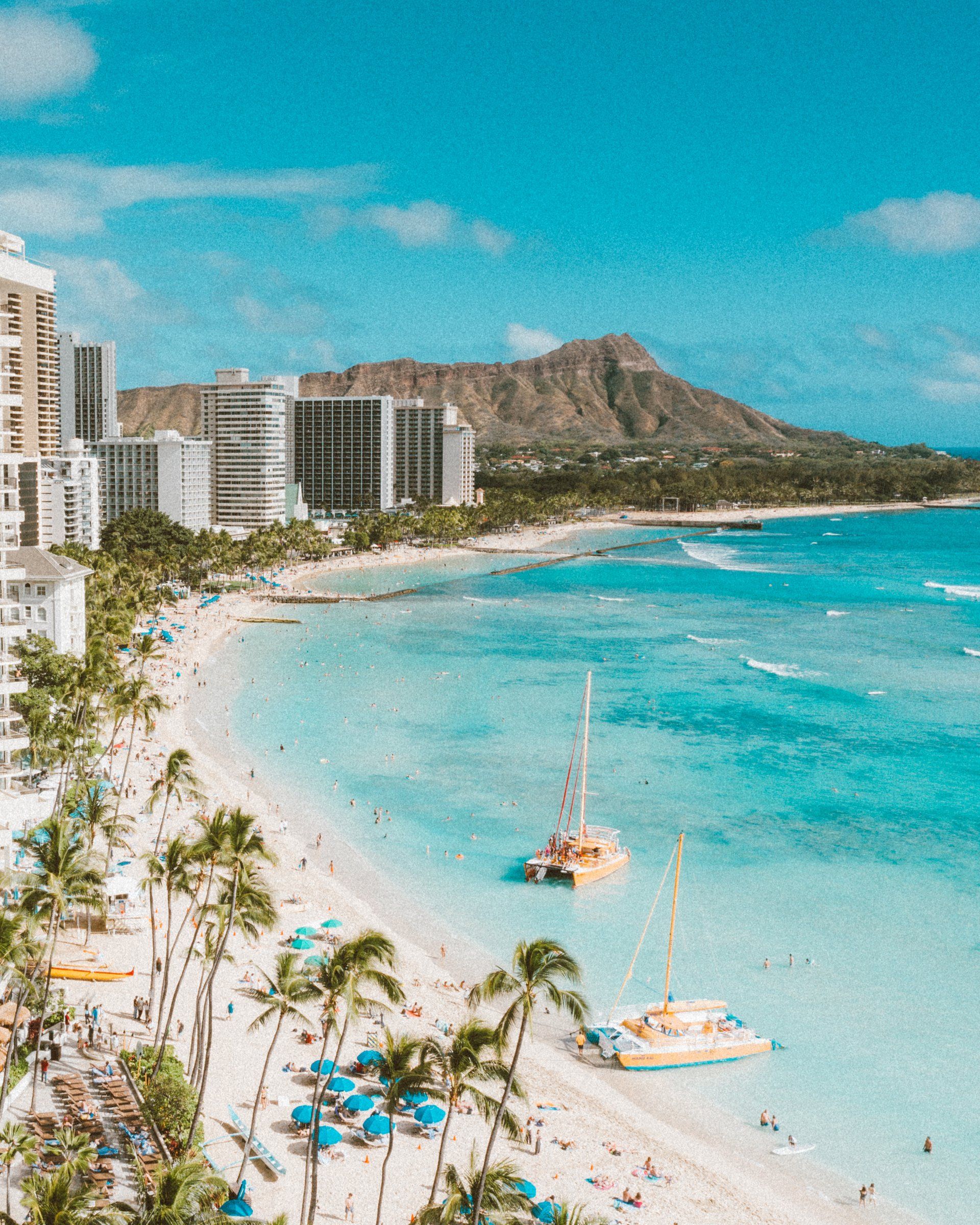 An aerial view of a beach with a mountain in the background